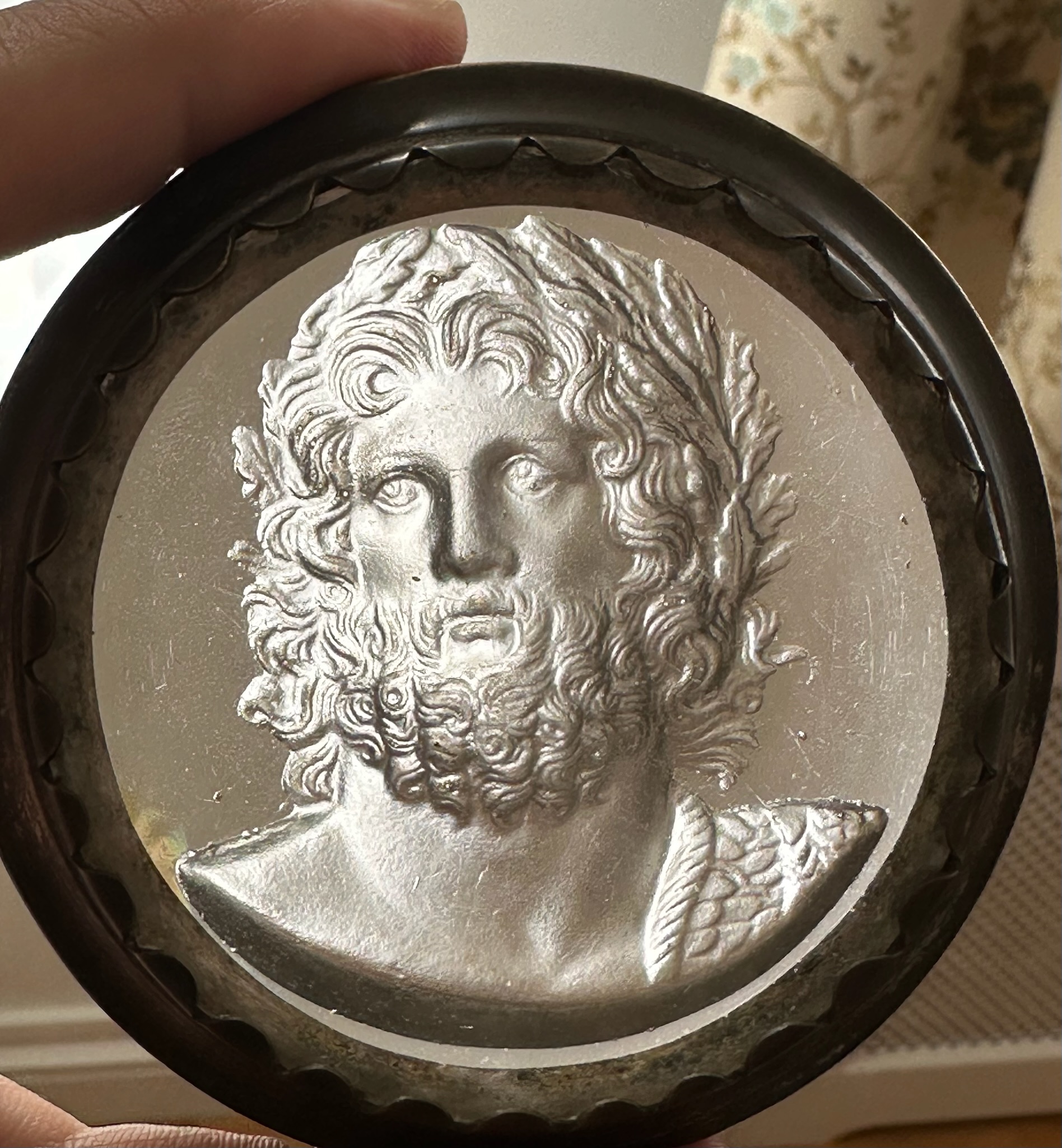 An early 19th-century silvered brass snuff box, the lid set with a large glass paste of Jupiter Aegiochus after the Zulian intaglio.