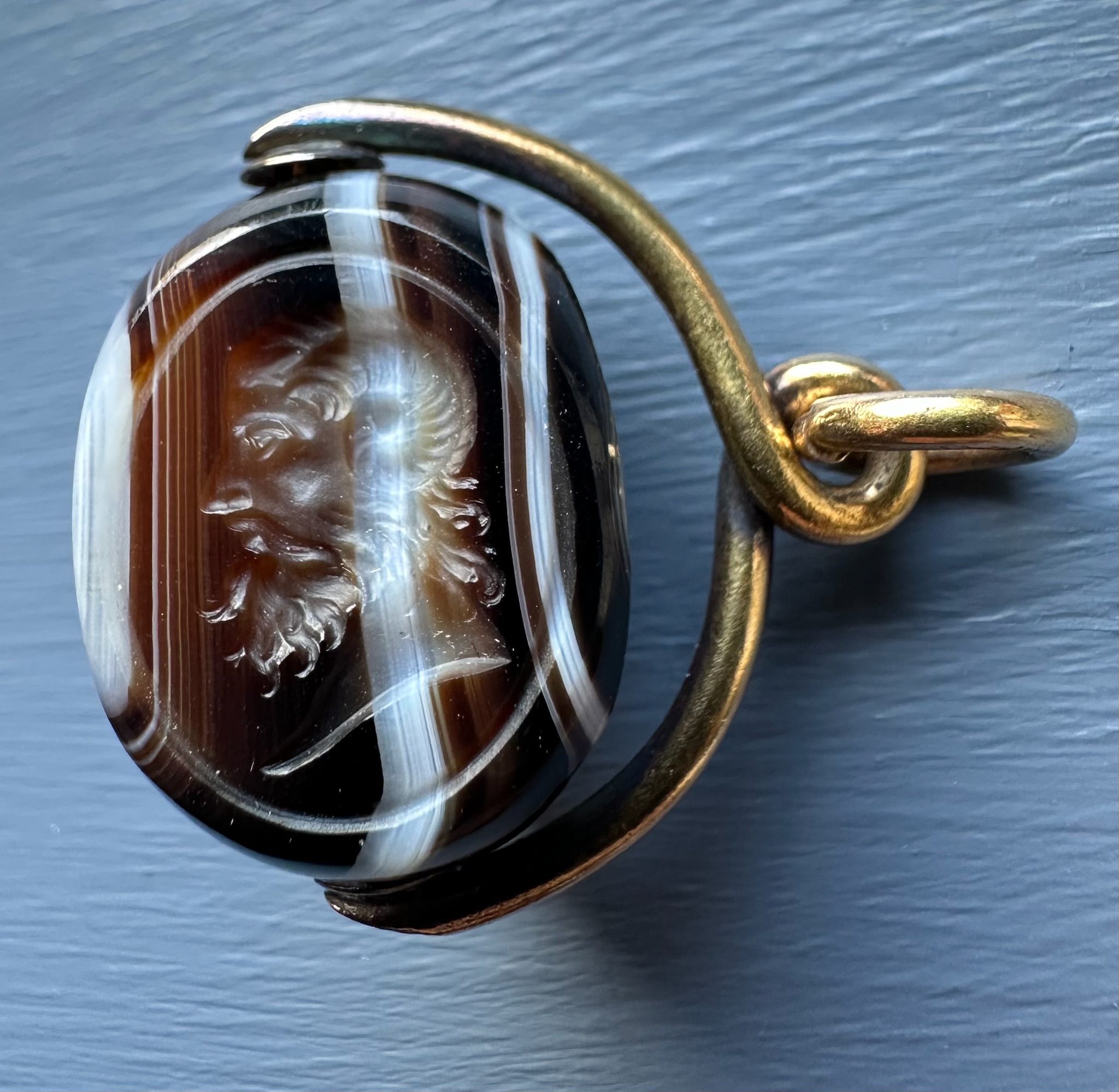 A Victorian banded agate engraved swivel seal with gold mounting. Portrait of Jupiter Ammon