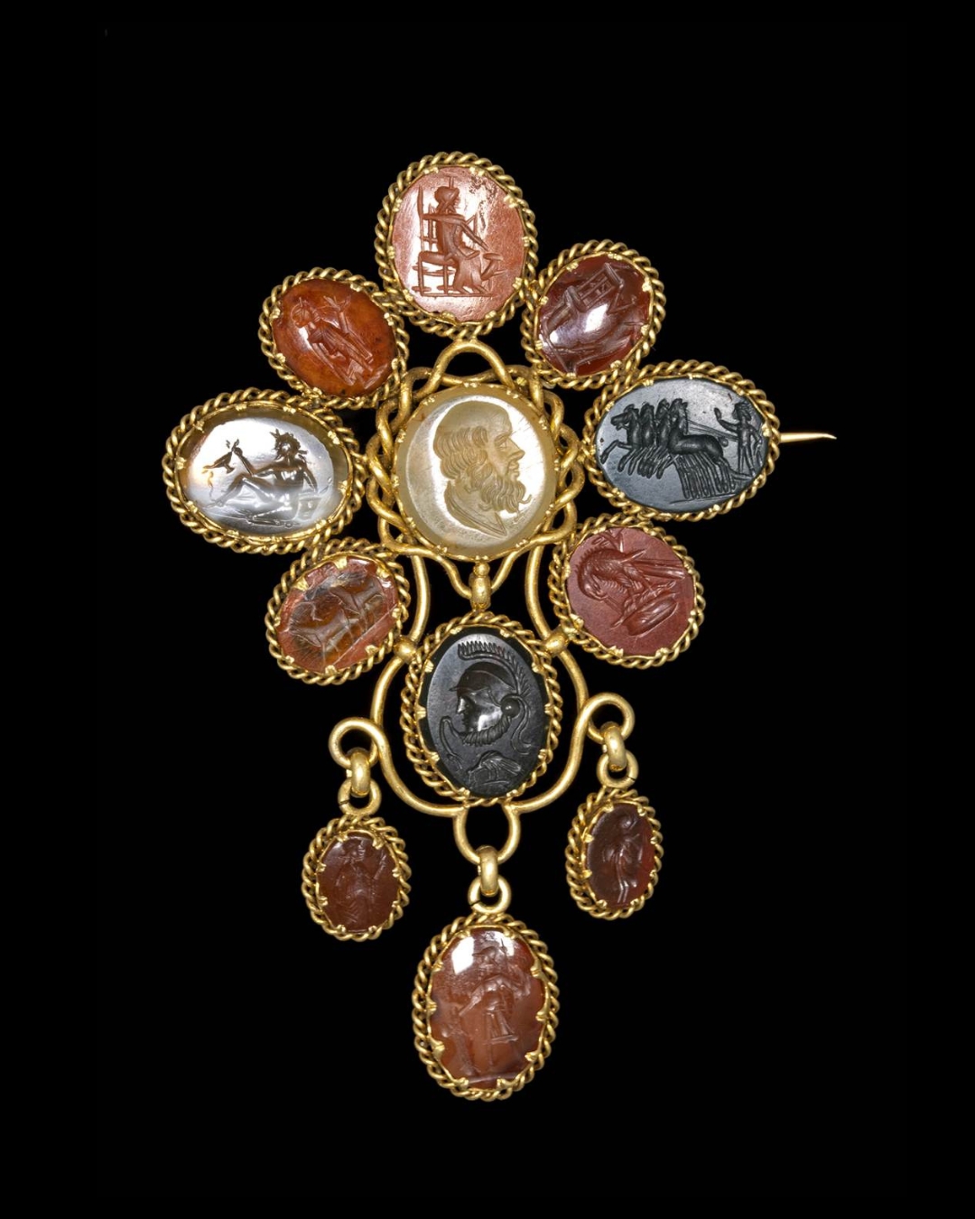 A LARGE VICTORIAN GOLD BROOCH SET WITH 12 HARDSTONES INTAGLIOS. VARIOUS SUBJECTS.