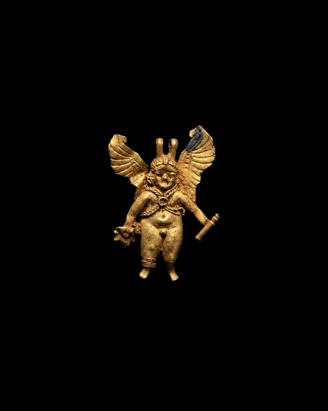 An Hellenistic gold winged Eros pendant.