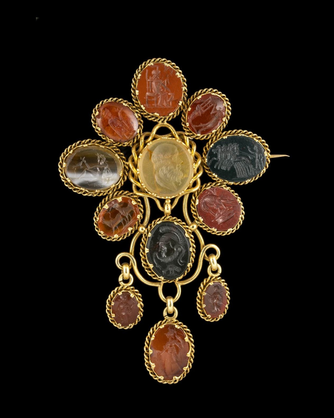A LARGE VICTORIAN GOLD BROOCH SET WITH 12 HARDSTONES INTAGLIOS. VARIOUS SUBJECTS.