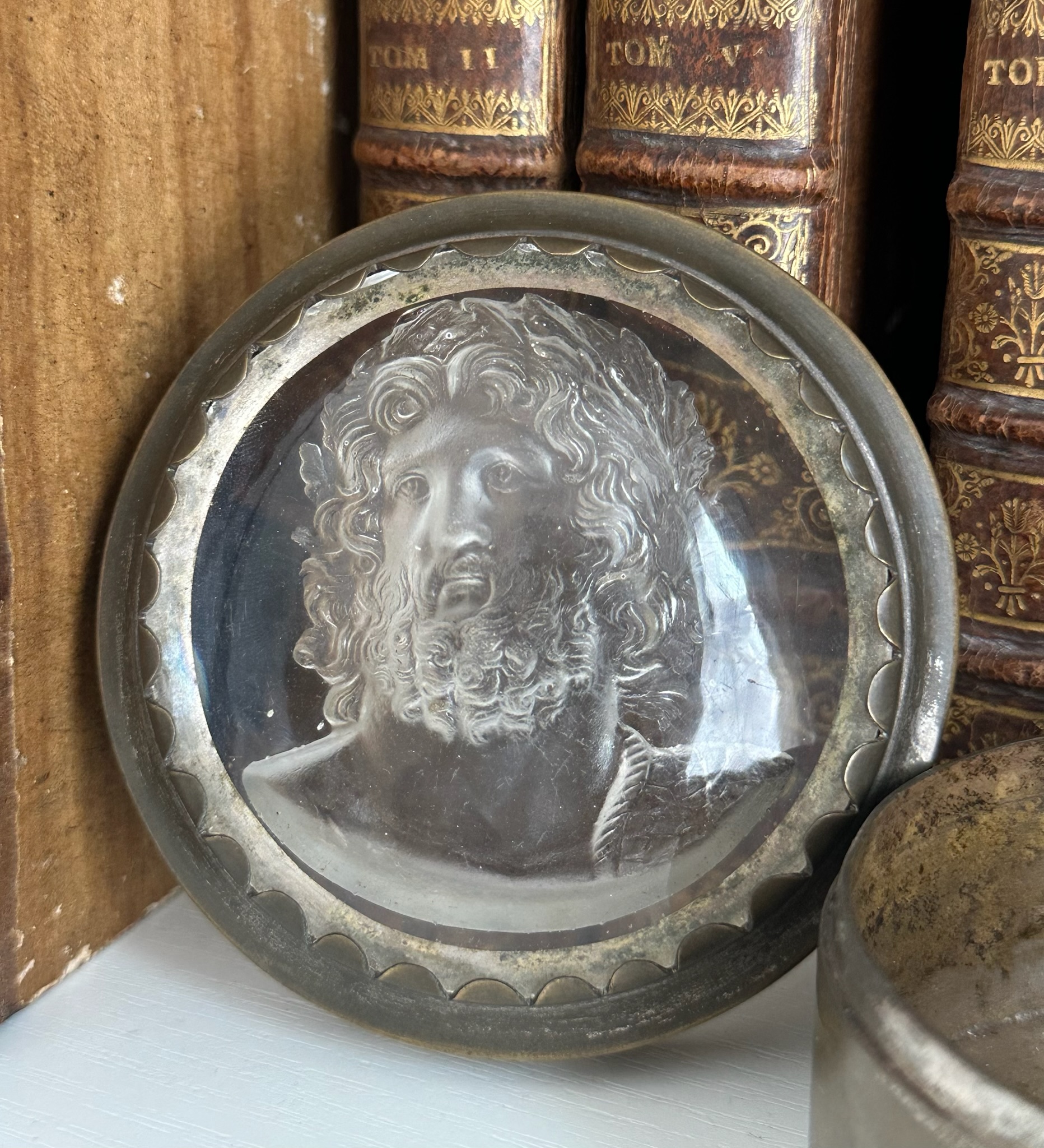 An early 19th-century silvered brass snuff box, the lid set with a large glass paste of Jupiter Aegiochus after the Zulian intaglio.