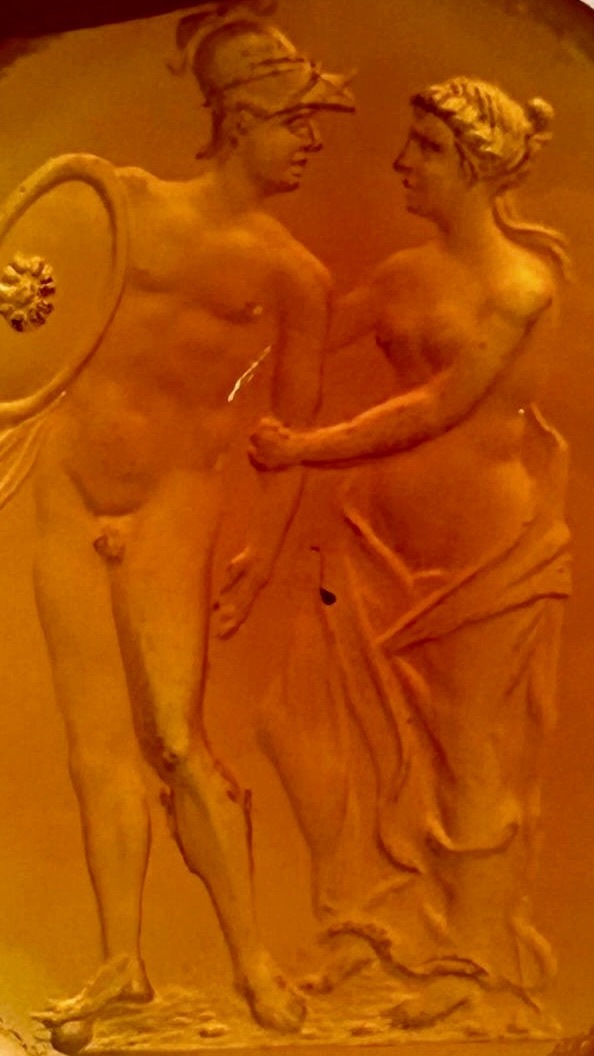 A Large Neoclassical carnelian intaglio set in a later massive gold ring. Mars and Venus.
