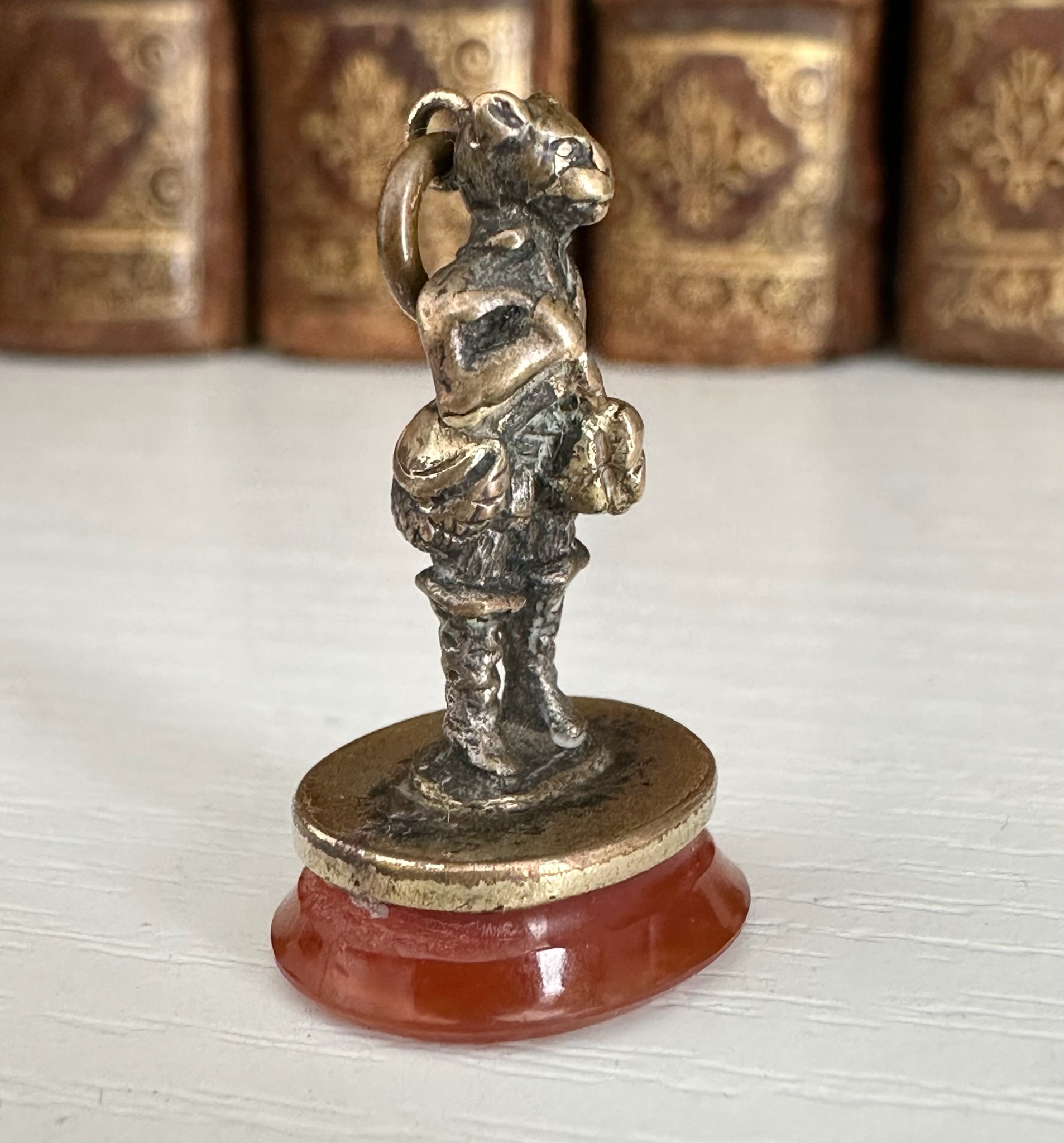 A 19th c. Puss in Boots gilt-metal fob seal with carnelian intaglio "Le diable emporte l'Amour".