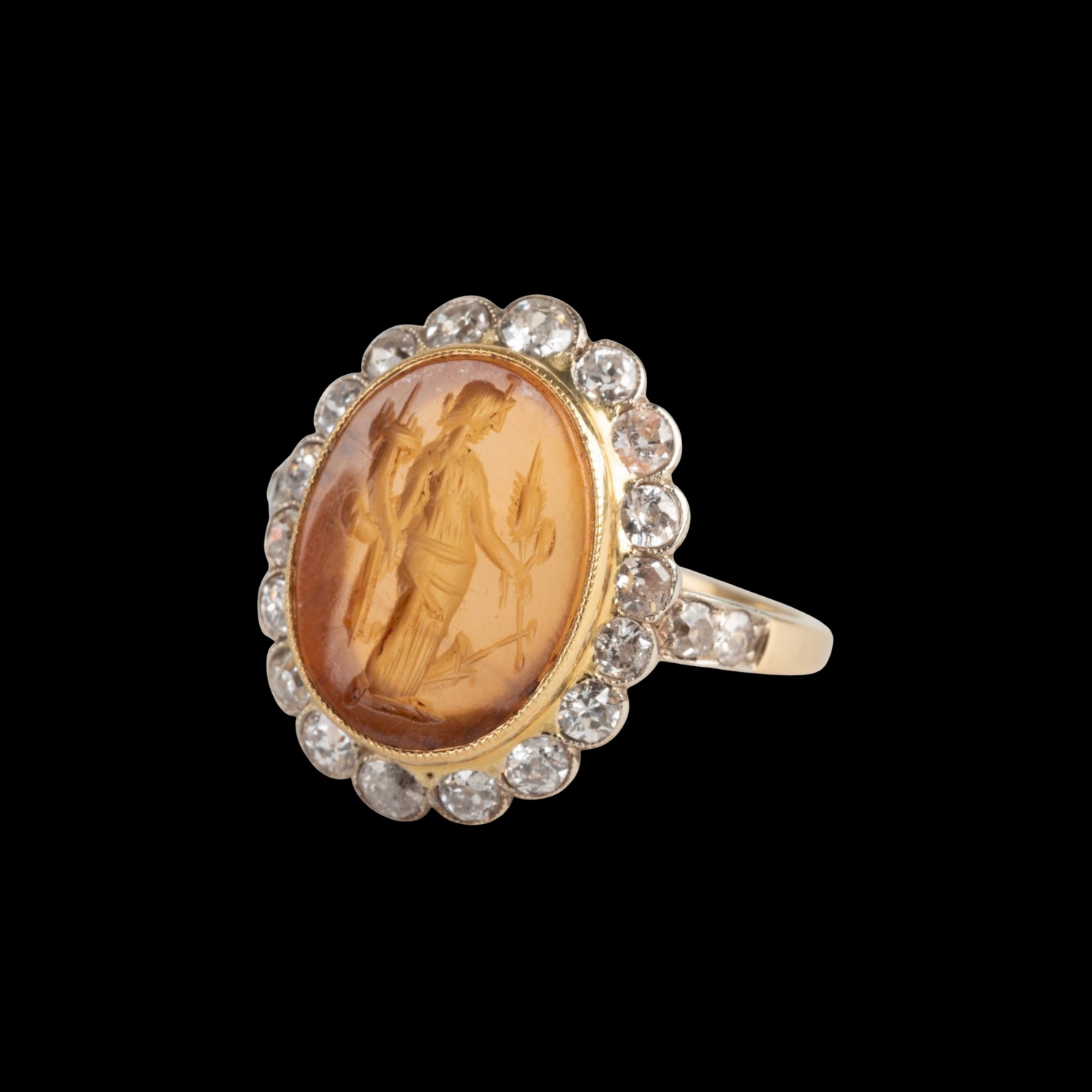 A Vintage two tone gold ring with diamonds and set with a Roman Carnelian Intaglio. Fortuna Tyche.
