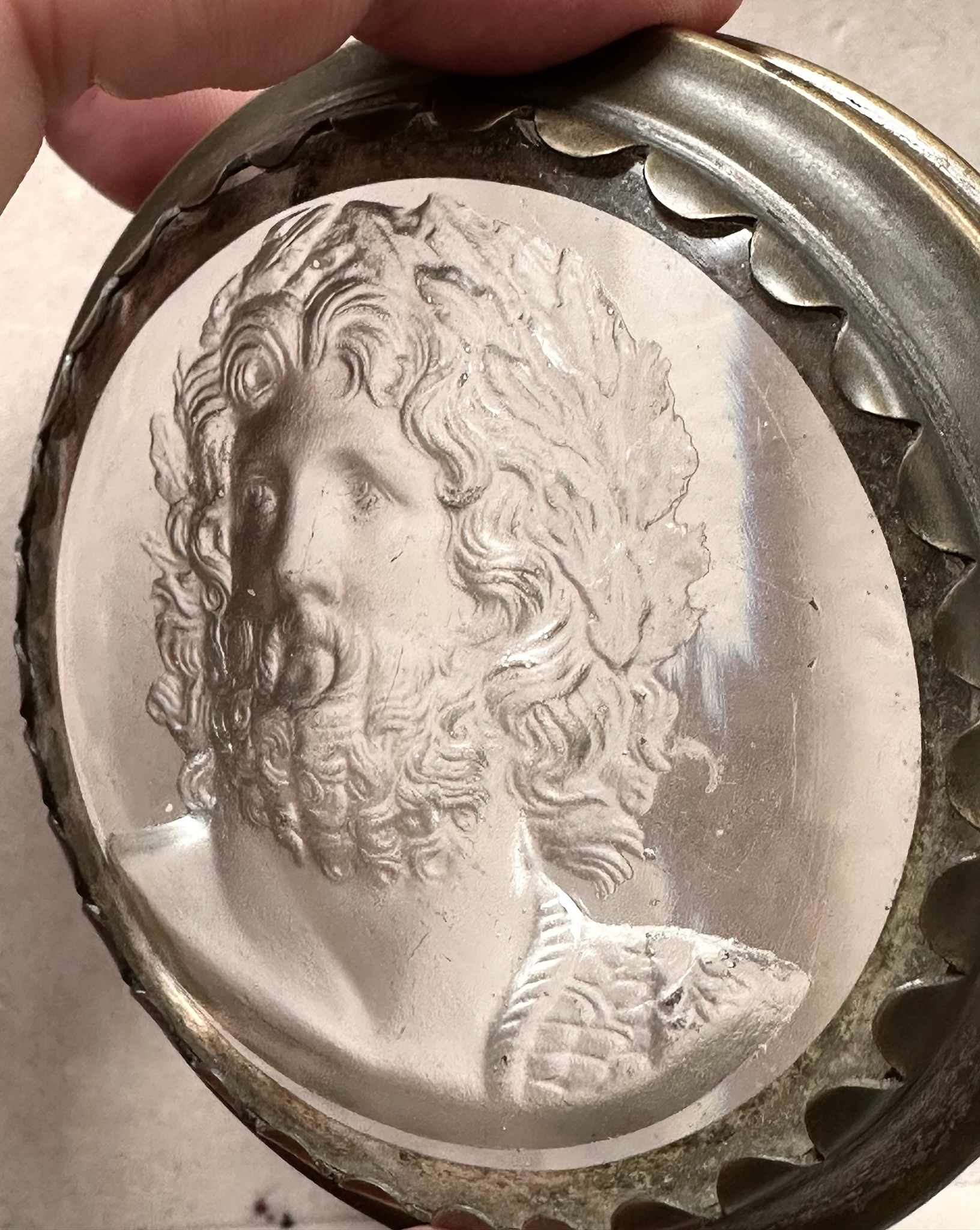 An early 19th-century silvered brass snuff box, the lid set with a large glass paste of Jupiter Aegiochus after the Zulian intaglio.
