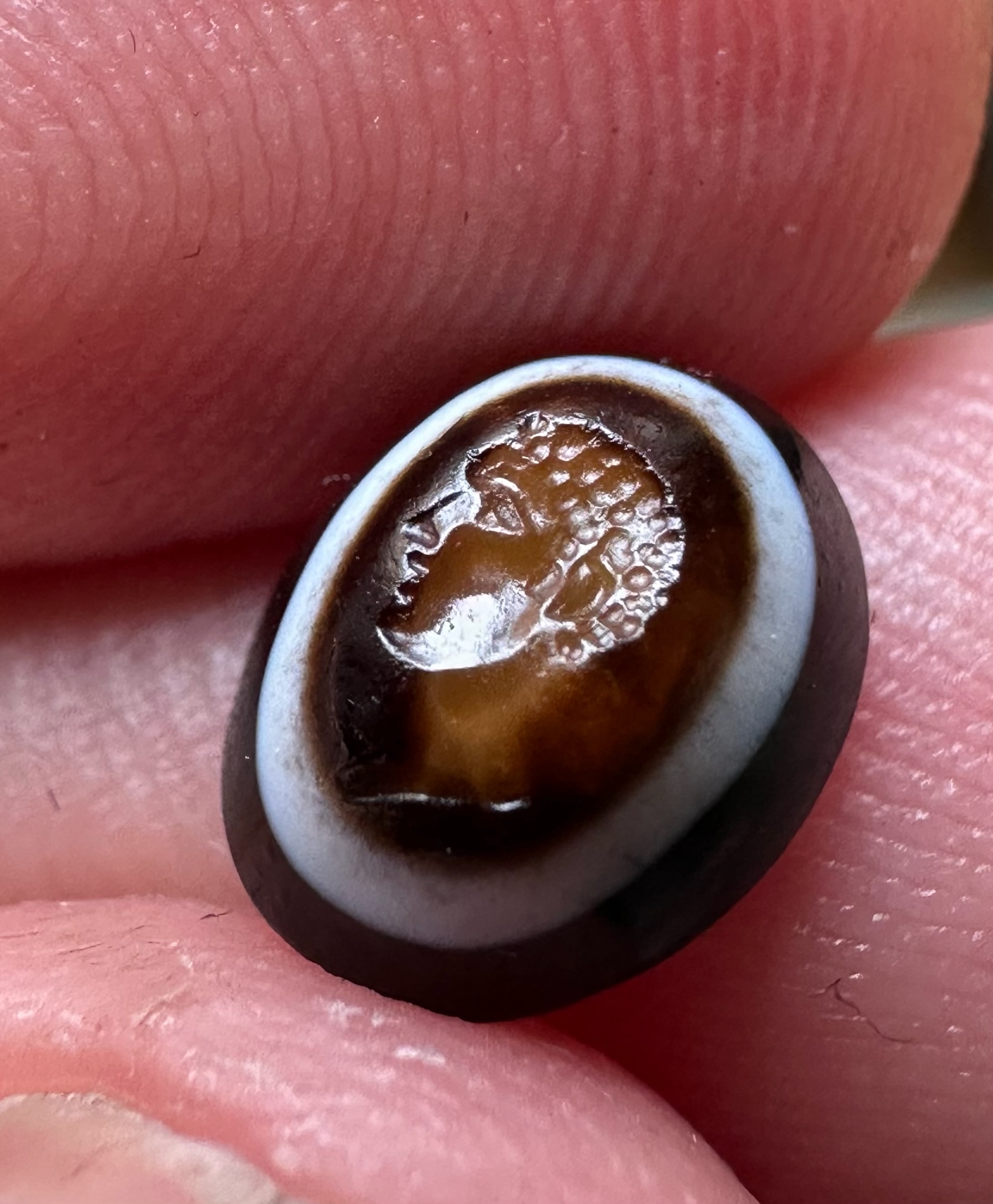 A Roman three-layered agate intaglio. Portrait of young Hercules.