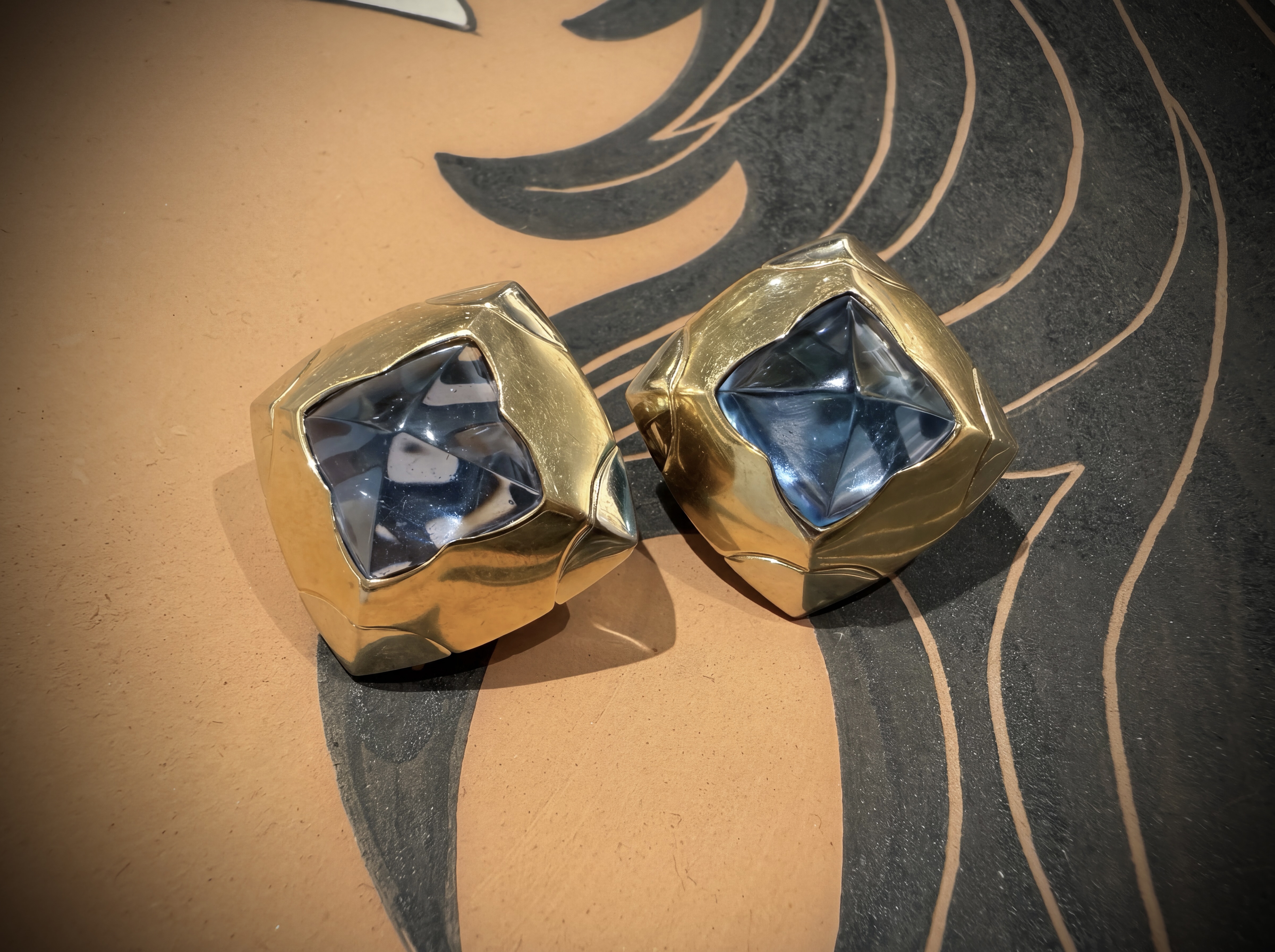 Bulgari. A blue topaz and gold demi-parure— a pair of ear clips and a ring en suite