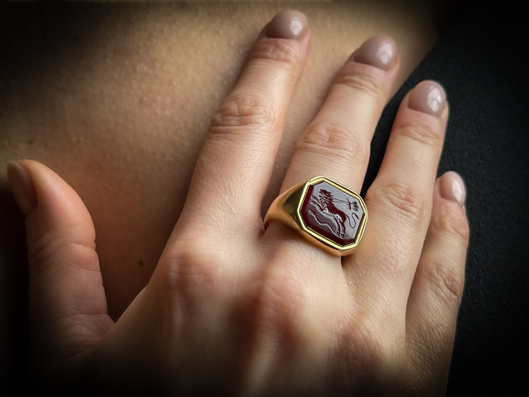 Roman, Late 19th century, A 19th century gold ring set with a Roman carnelian intaglio. Allegorical scene with lion.  (1st-2nd century A.D. )