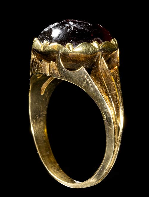 A 19th century gold ring set with an early Roman garnet intaglio. Victory. 