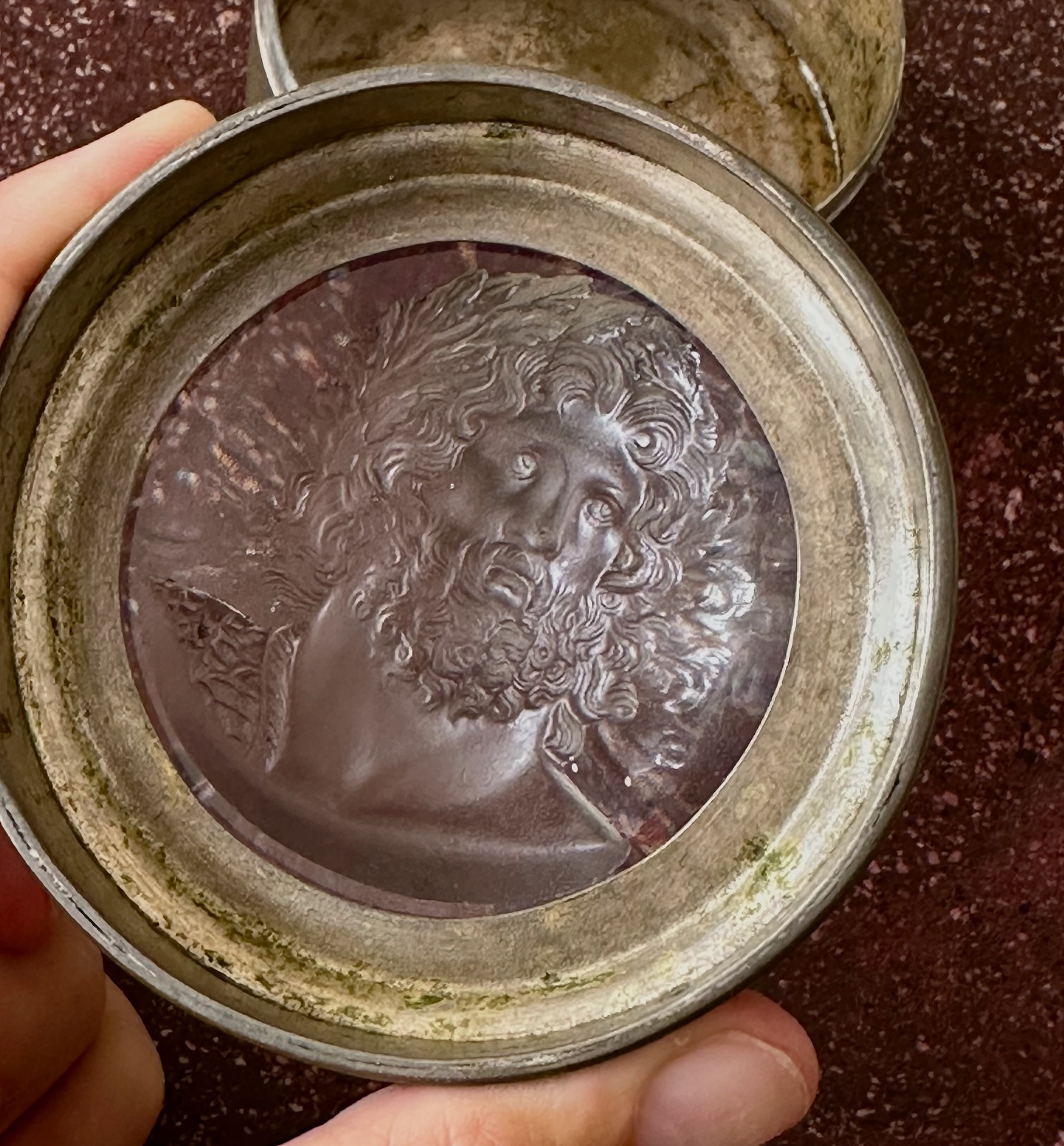 An early 19th-century silvered brass snuff box, the lid set with a large glass paste of Jupiter Aegiochus after the Zulian intaglio.