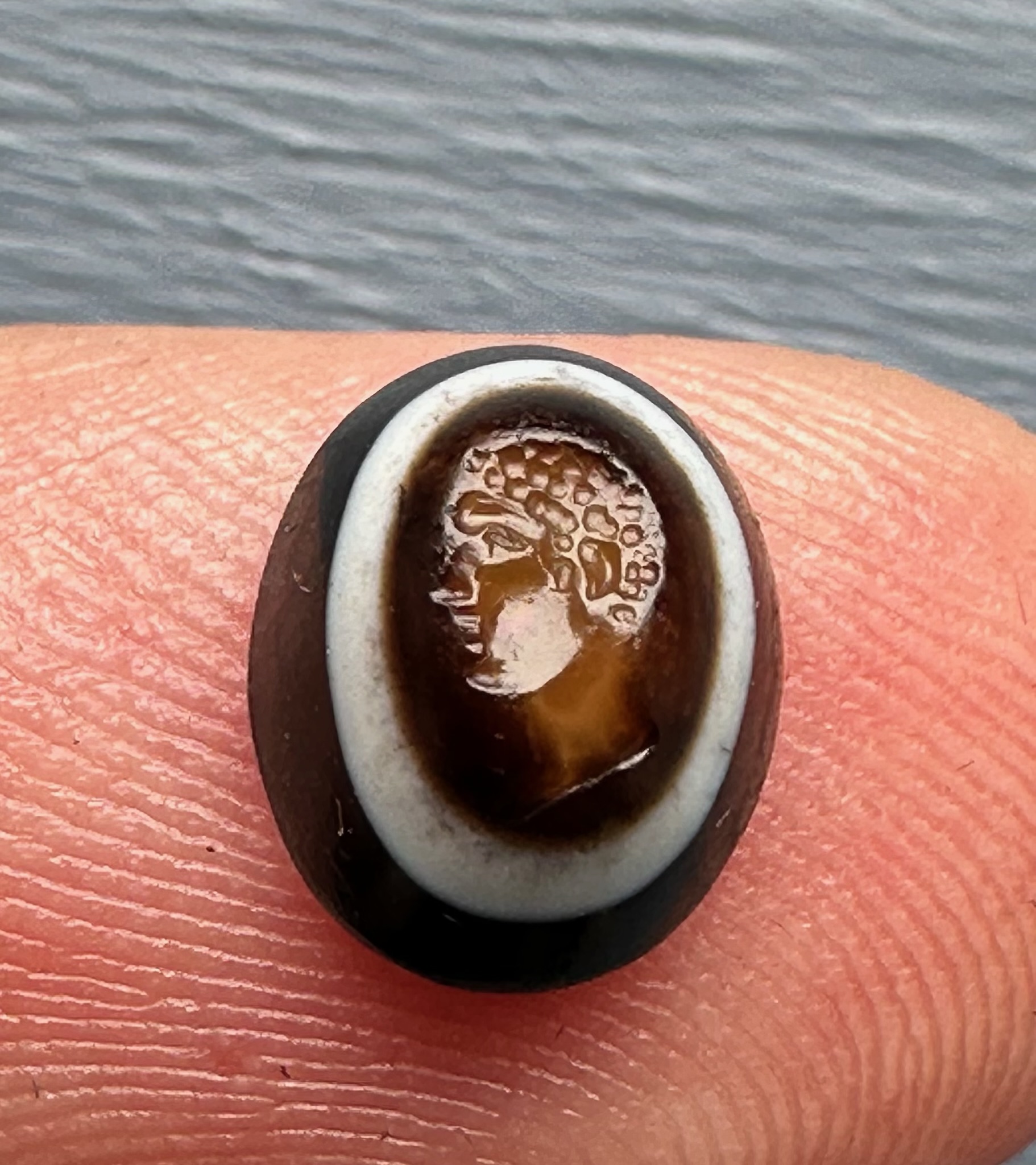 A Roman three-layered agate intaglio. Portrait of young Hercules.