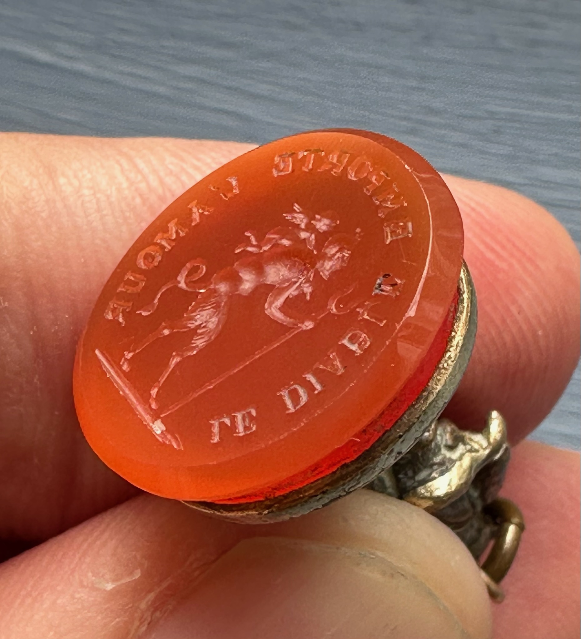 A 19th c. Puss in Boots gilt-metal fob seal with carnelian intaglio "Le diable emporte l'Amour".