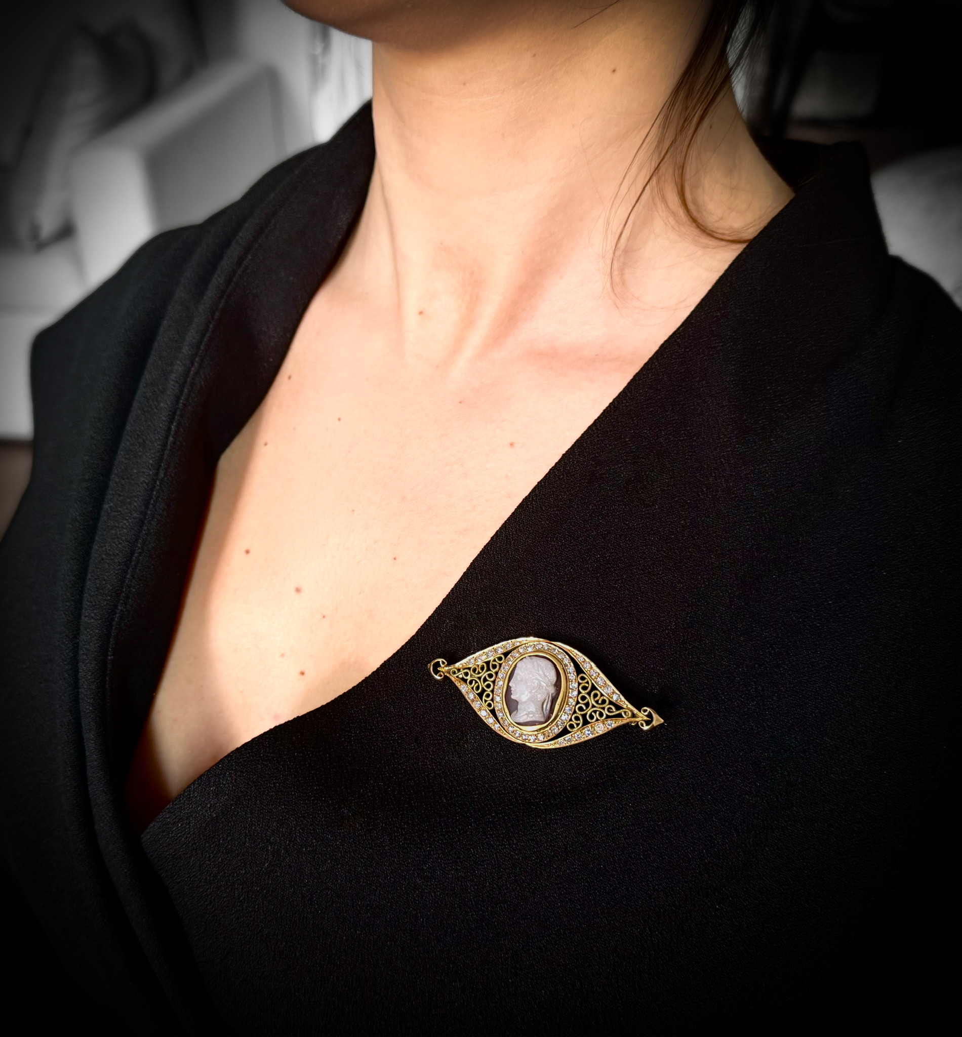 Late 19th century, A Late 19th century gold brooch with diamonds and set with a central agate cameo. Head of an Emperor. 