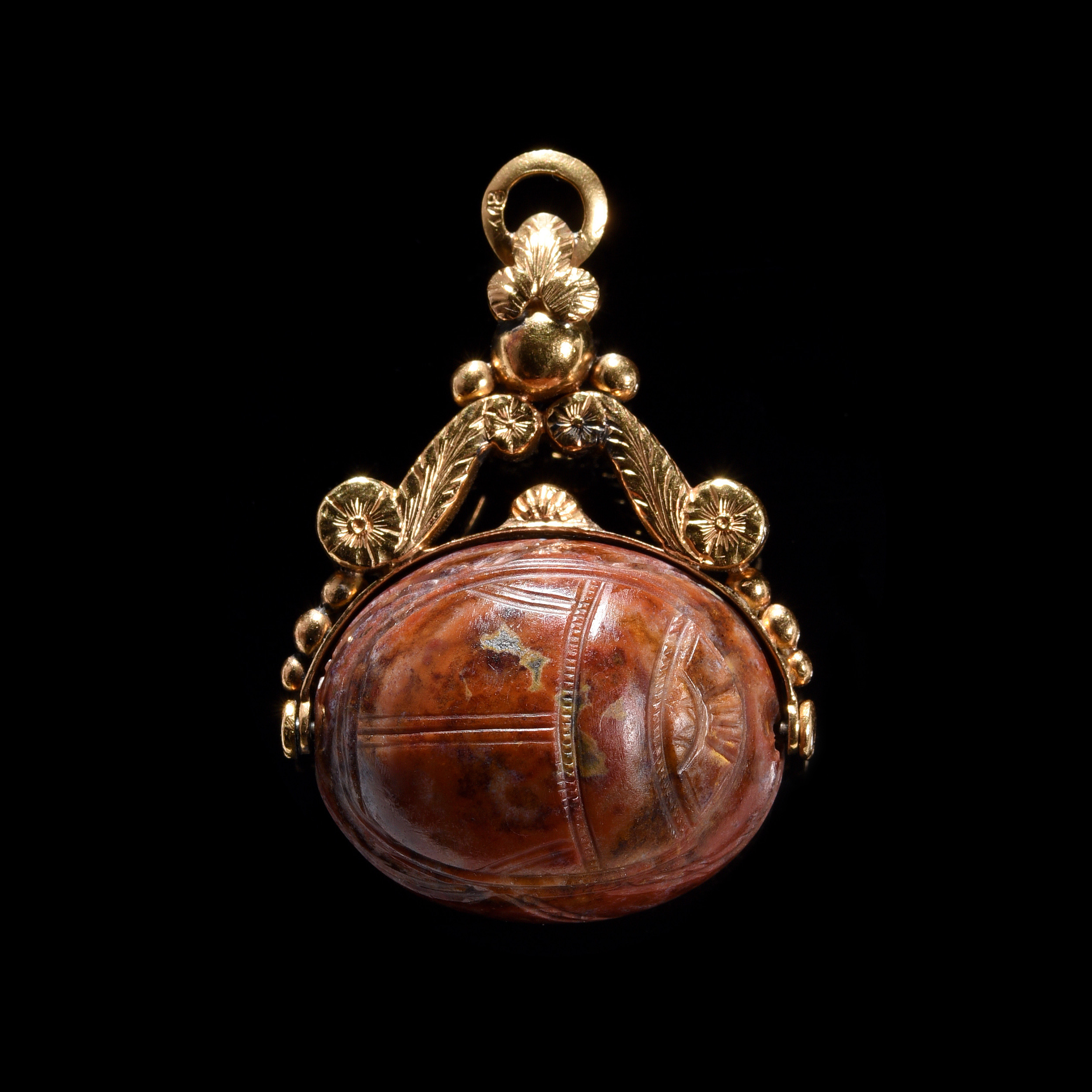 A late 18th c. gold swivel chiseled seal pendant set with a large red jasper engraved scarab. Jupiter.