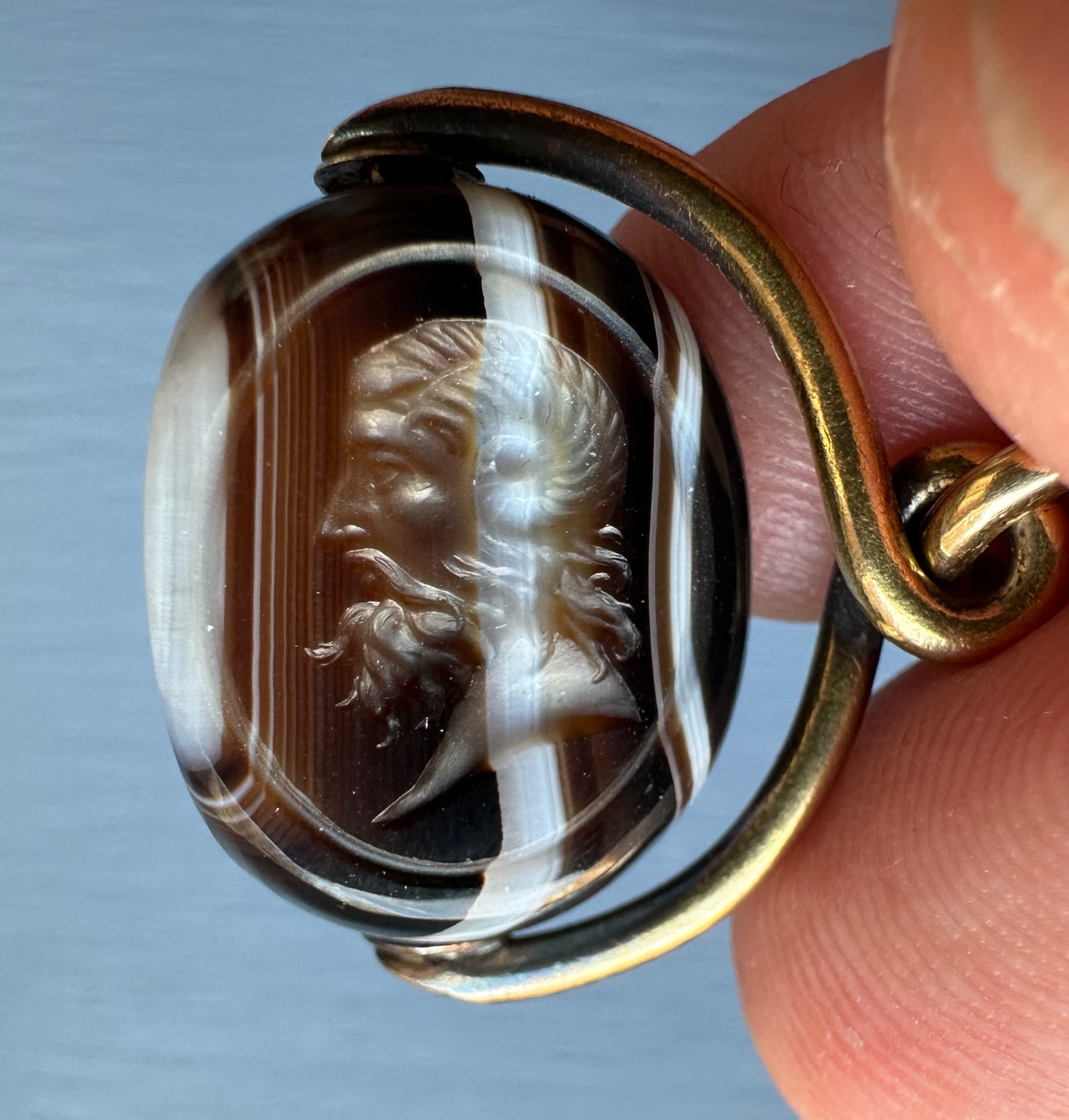A Victorian banded agate engraved swivel seal with gold mounting. Portrait of Jupiter Ammon