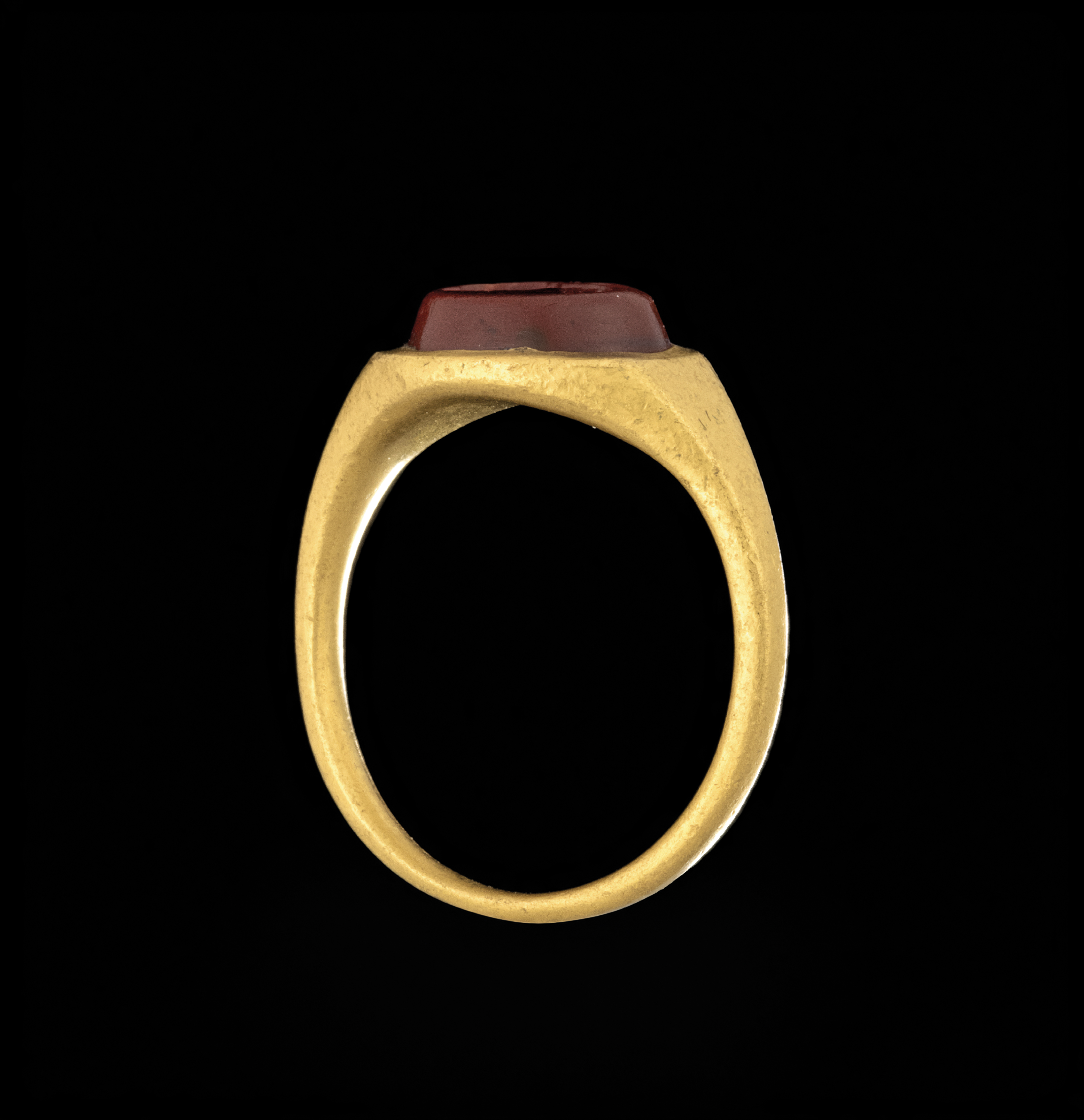 A Roman gold ring set with a red jasper intaglio. Bust of Mercury. 