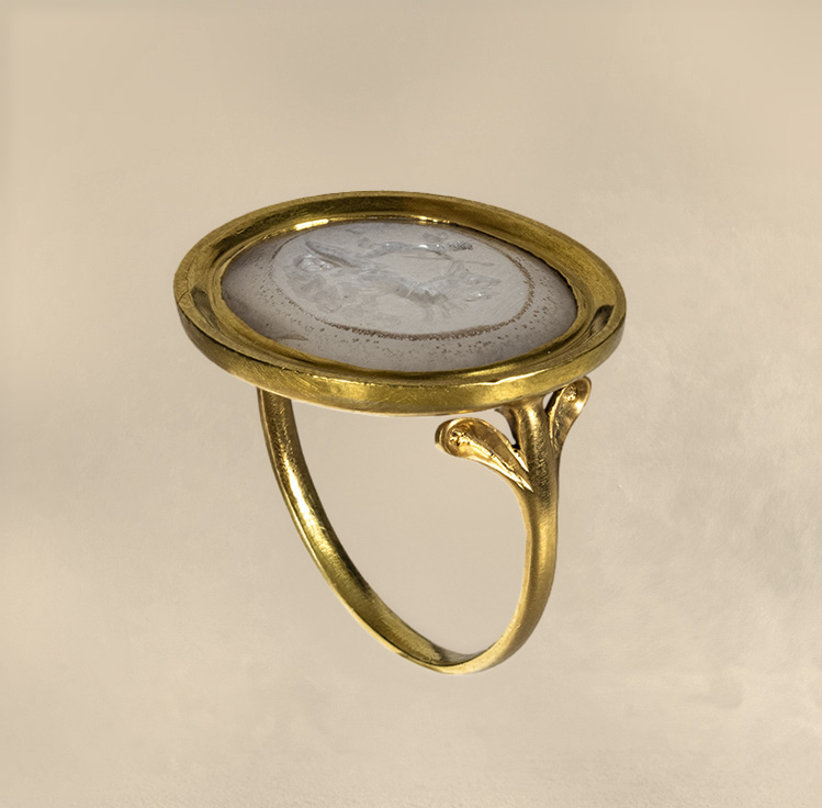 A Neoclassical chalcedony intaglio set in a 22k gold ring. The Conquest of Love.