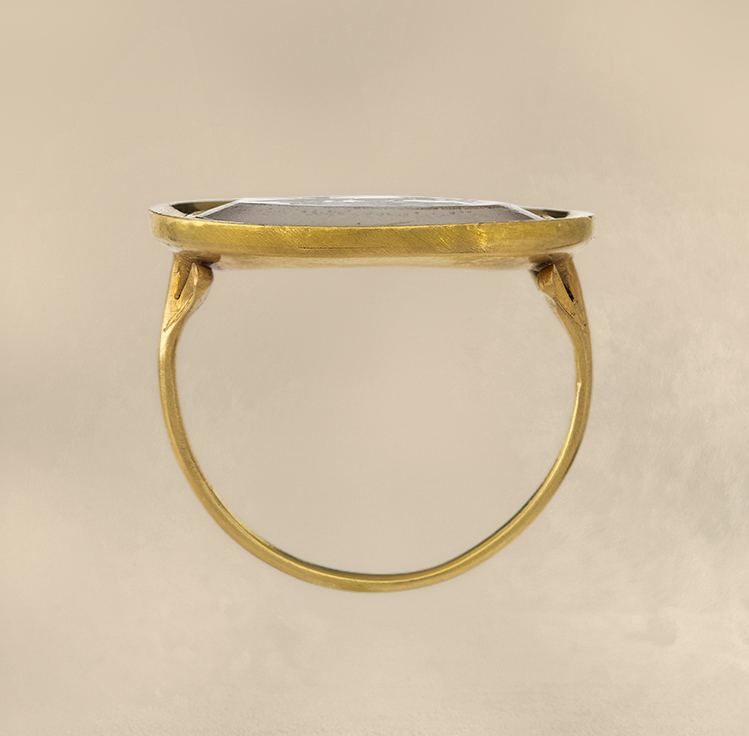 A Neoclassical chalcedony intaglio set in a 22k gold ring. The Conquest of Love.