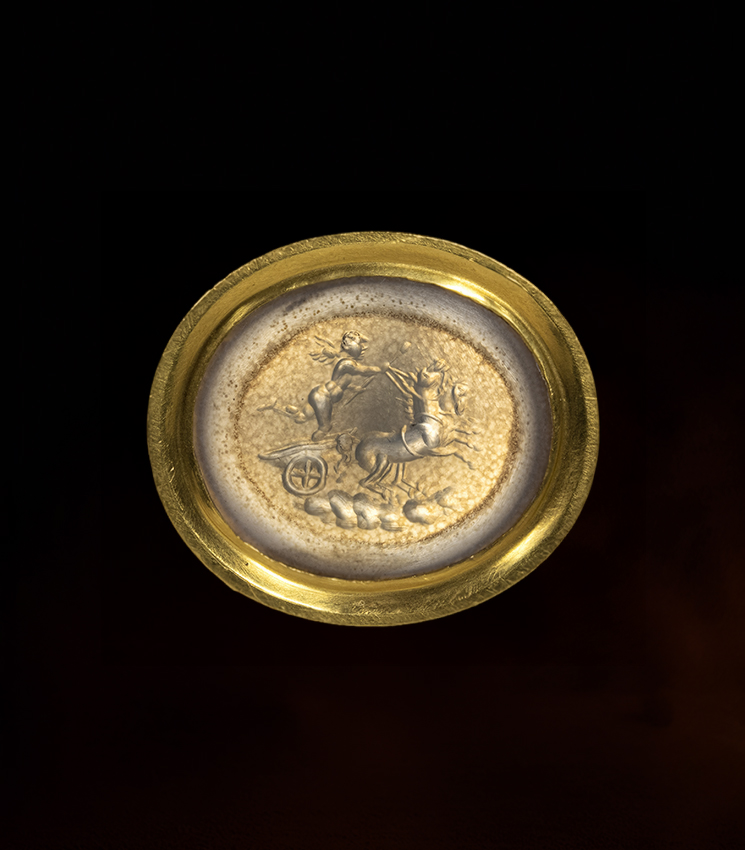 A Neoclassical chalcedony intaglio set in a 22k gold ring. The Conquest of Love.