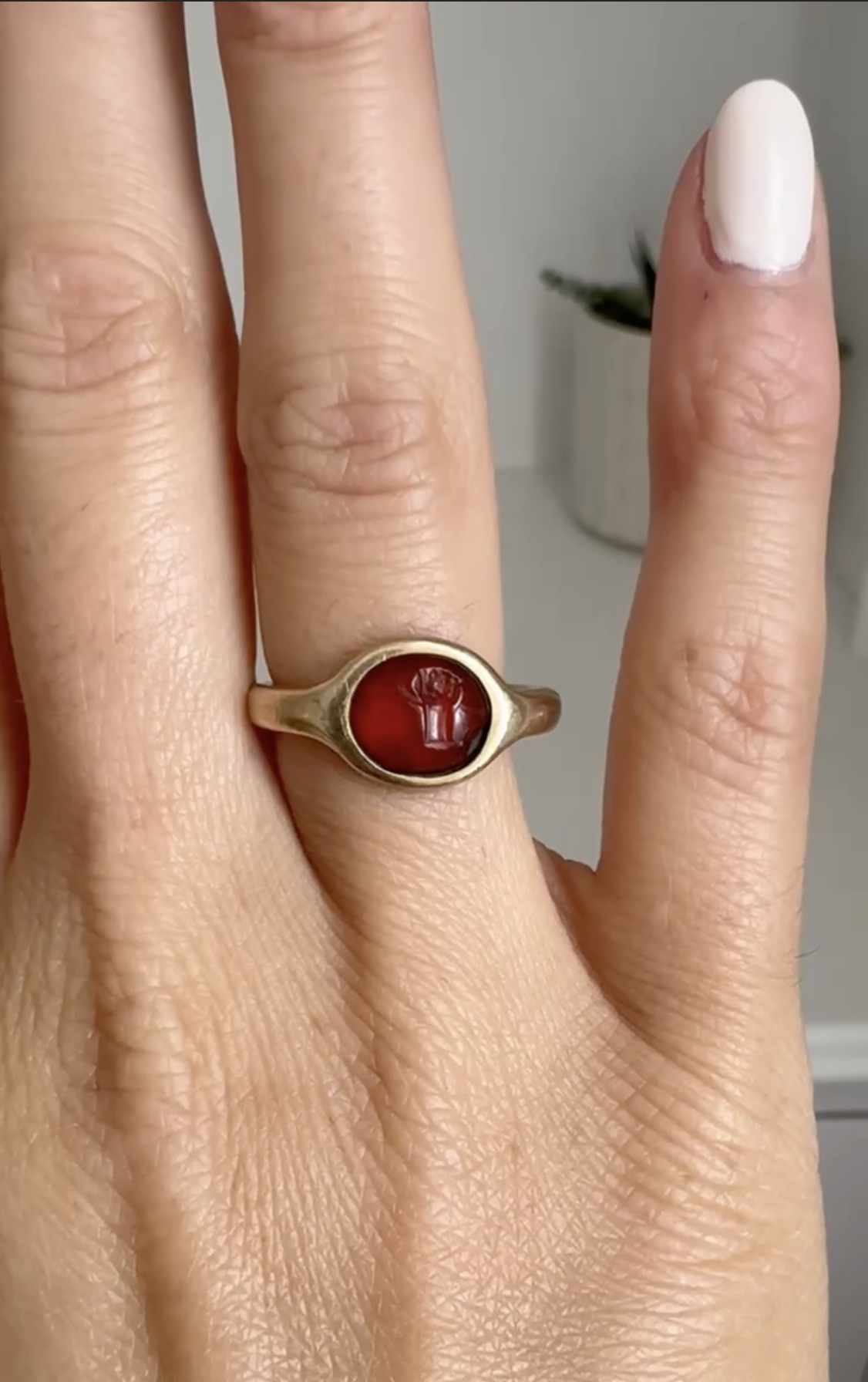 italic, modern, A gold ring set with an Italic carnelian intaglio. Hand with attributes.  (2nd-1st century BCE)