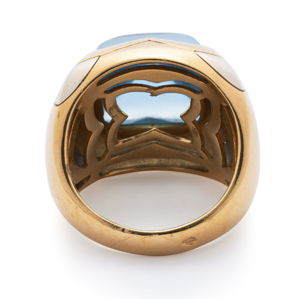 Bulgari. A blue topaz and gold demi-parure— a pair of ear clips and a ring en suite
