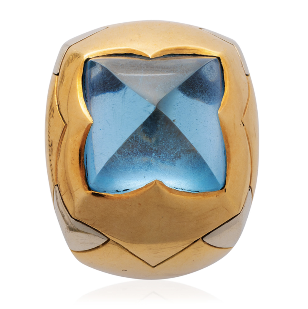 Bulgari. A blue topaz and gold demi-parure— a pair of ear clips and a ring en suite