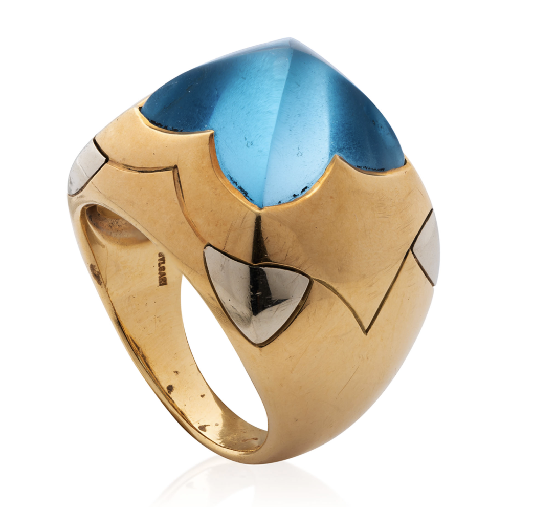 Bulgari. A blue topaz and gold demi-parure— a pair of ear clips and a ring en suite