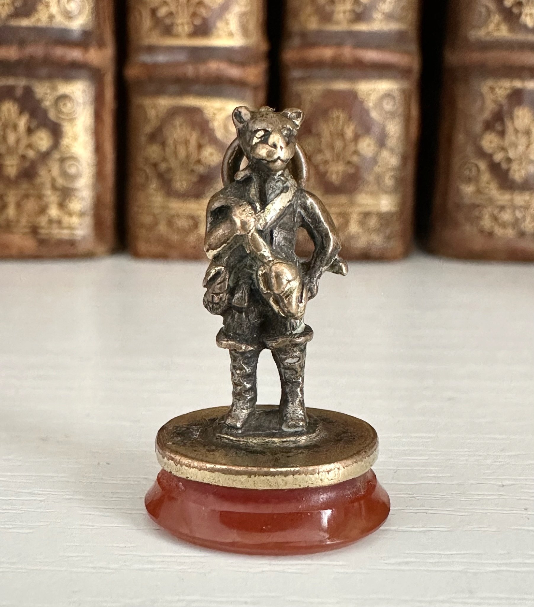 A 19th c. Puss in Boots gilt-metal fob seal with carnelian intaglio "Le diable emporte l'Amour".