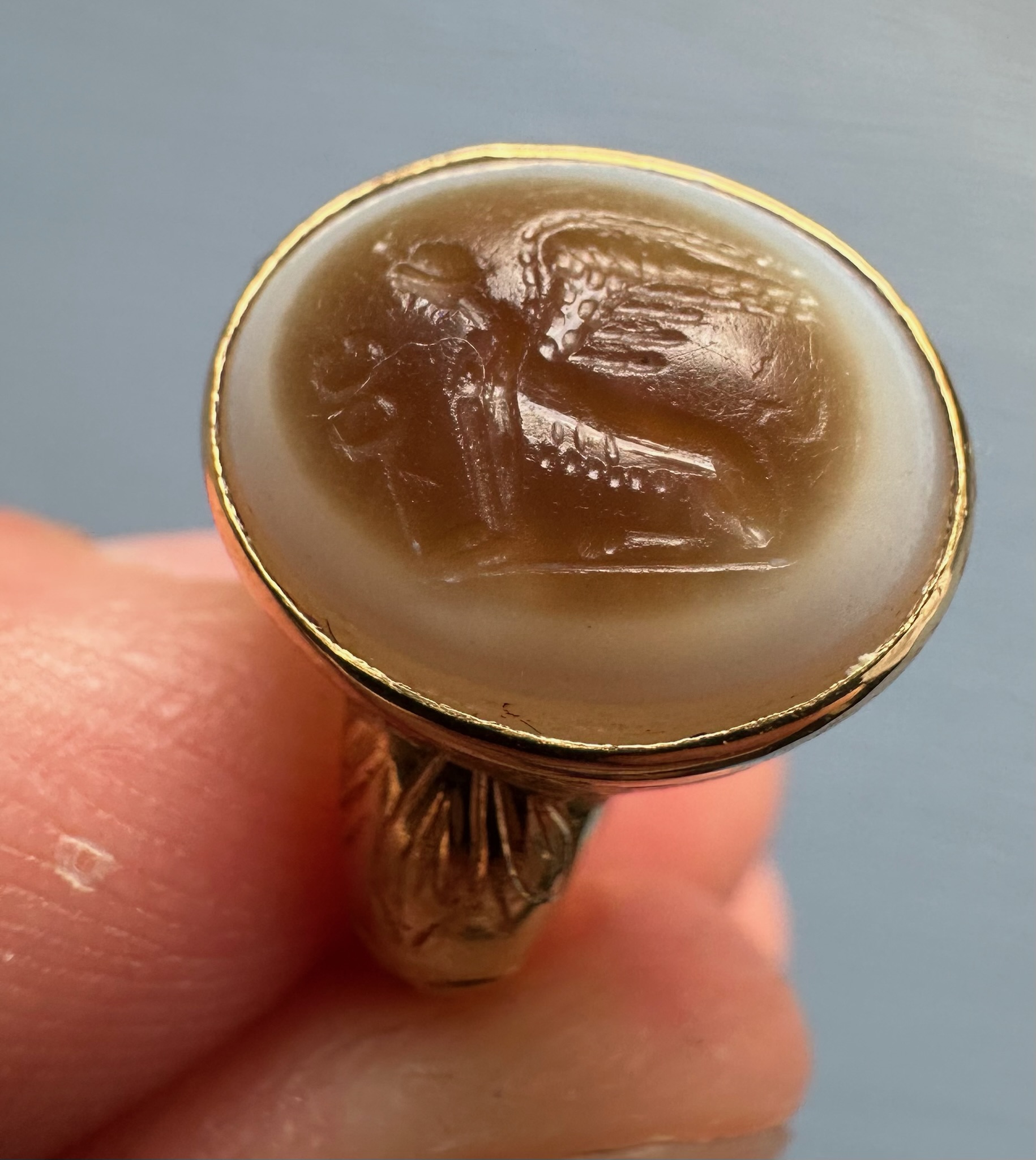 A 19th Century Gold Chiseled Signet Ring set with a Roman Sardonyx Intaglio — Sphinx with Caduceus
