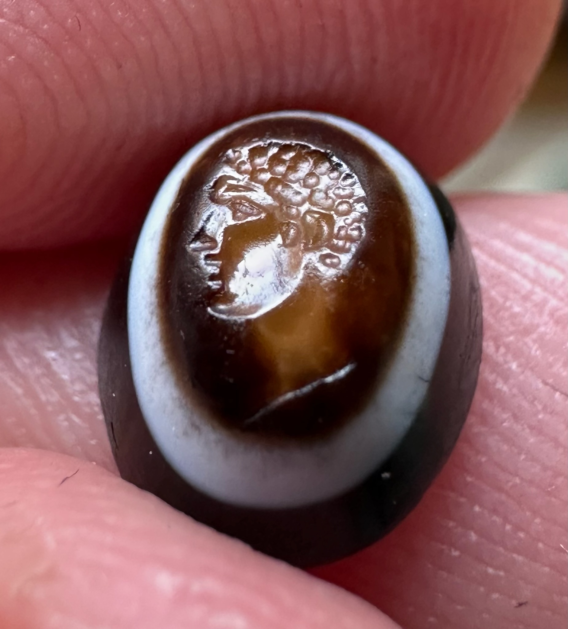 A Roman three-layered agate intaglio. Portrait of young Hercules.