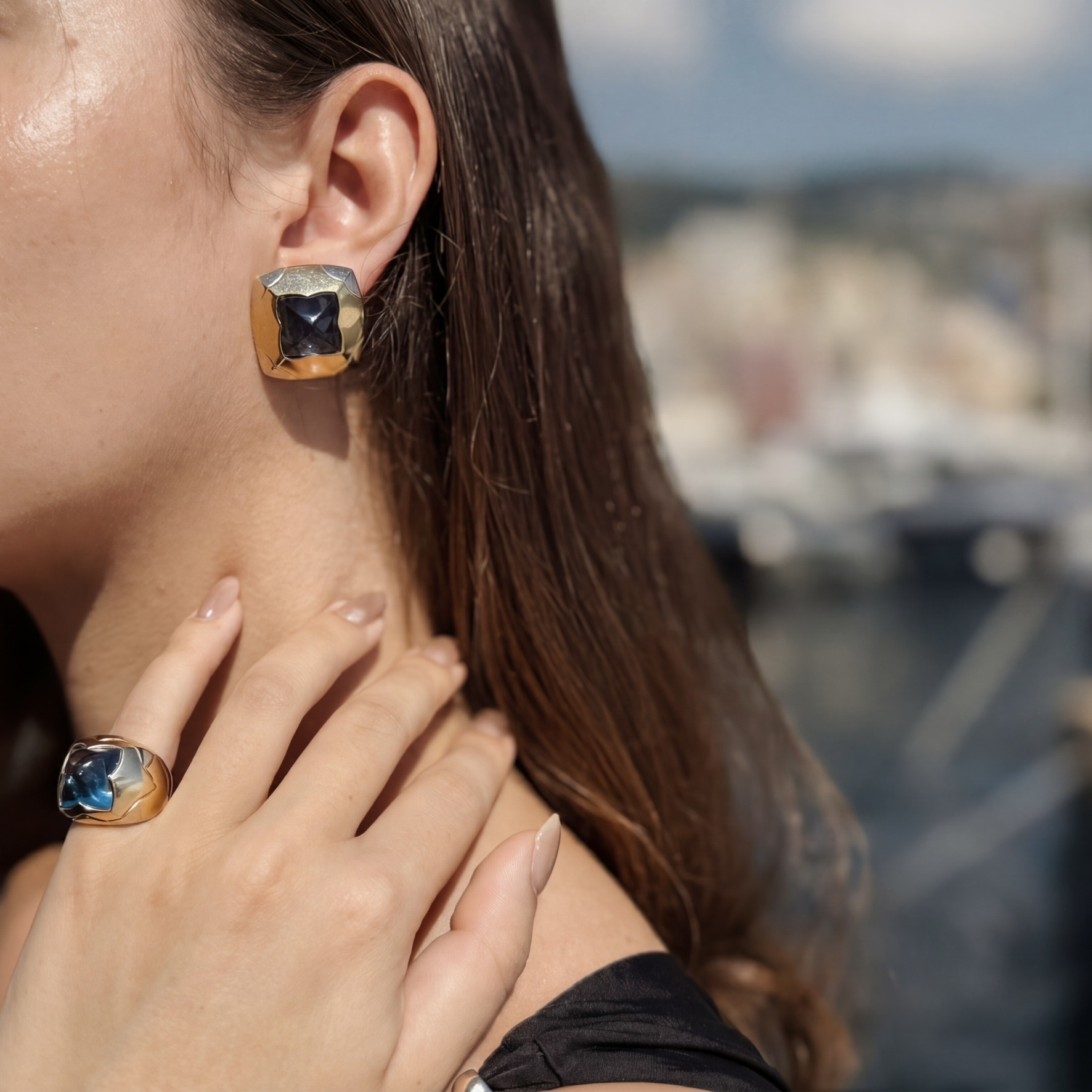 Bulgari. A blue topaz and gold demi-parure— a pair of ear clips and a ring en suite