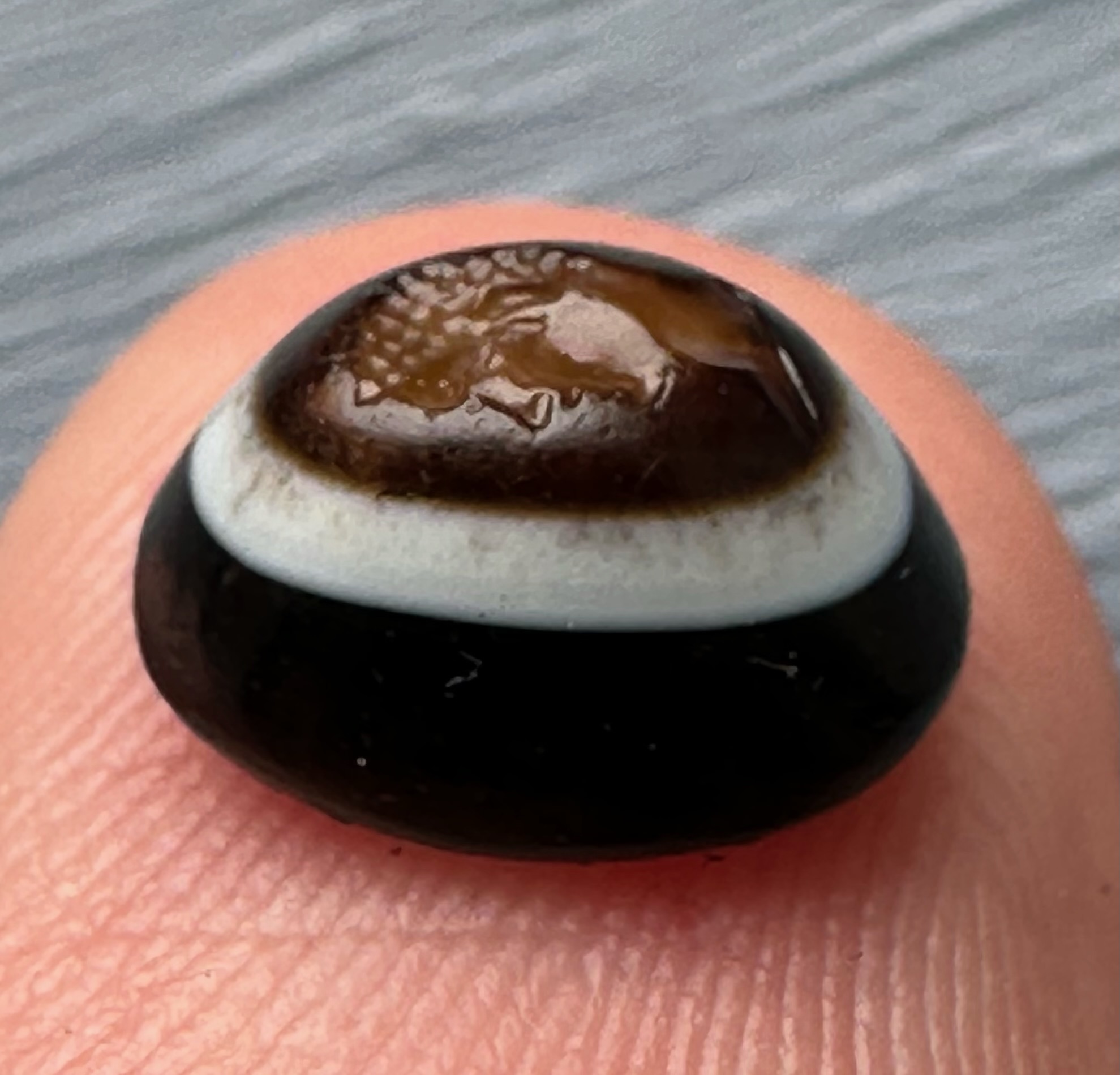 A Roman three-layered agate intaglio. Portrait of young Hercules.