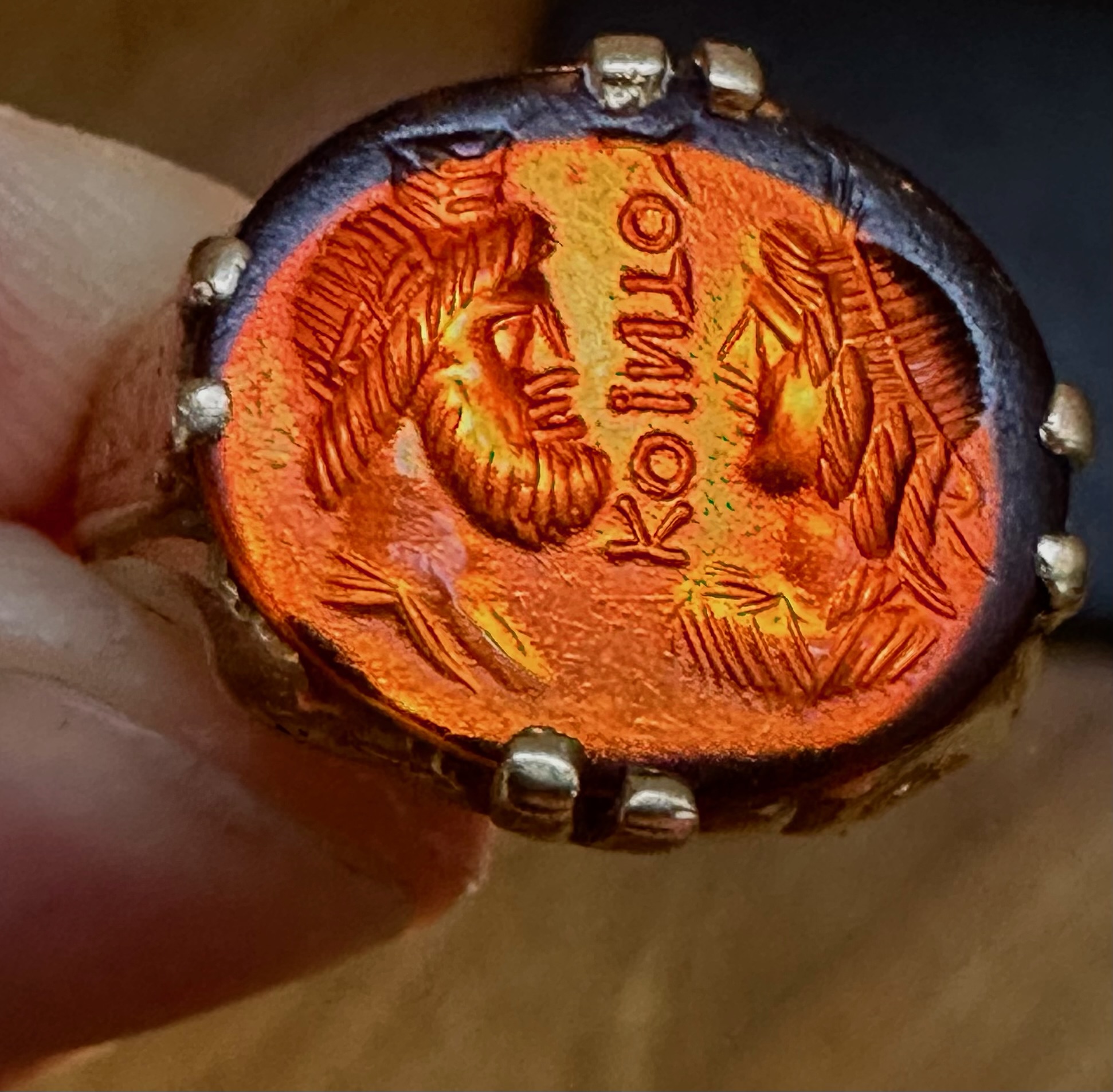 A Late 19th - early 20th c. gold chiseled ring set with a Roman Sard intaglio. Isis and Serapis with inscription.