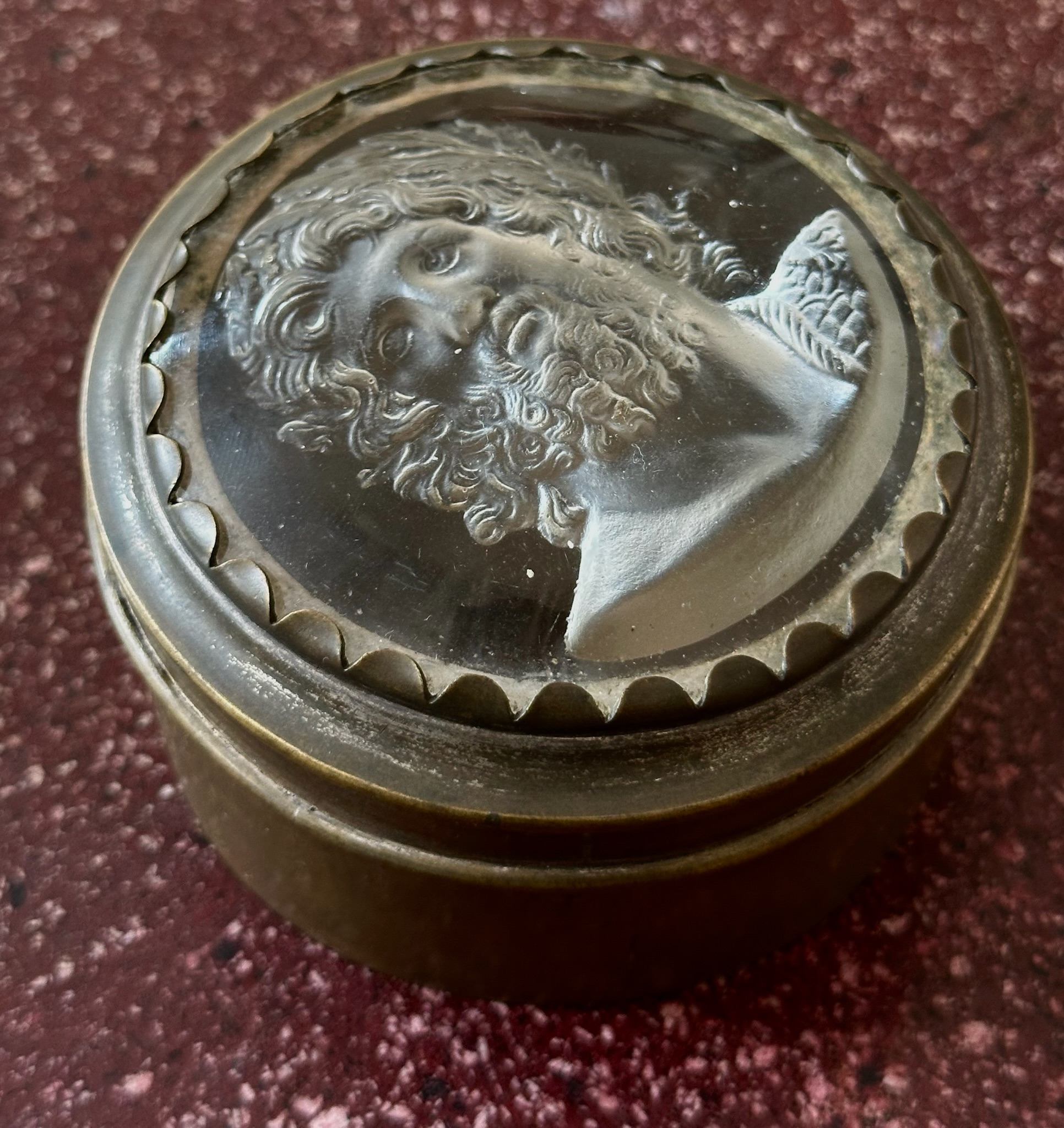 An early 19th-century silvered brass snuff box, the lid set with a large glass paste of Jupiter Aegiochus after the Zulian intaglio.