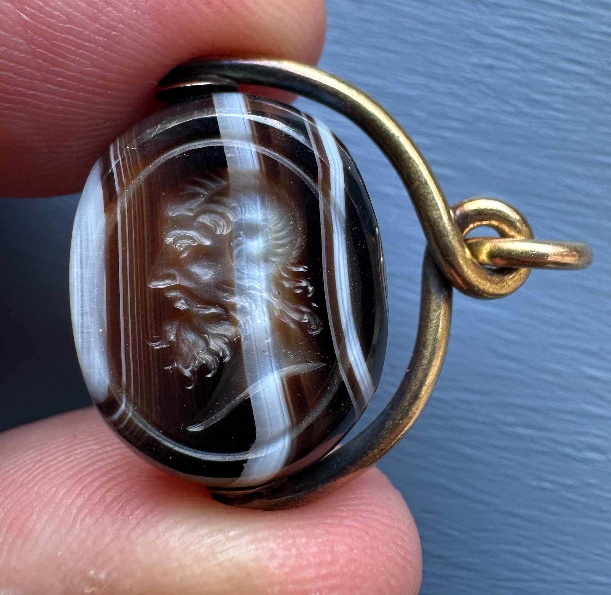 A Victorian banded agate engraved swivel seal with gold mounting. Portrait of Jupiter Ammon