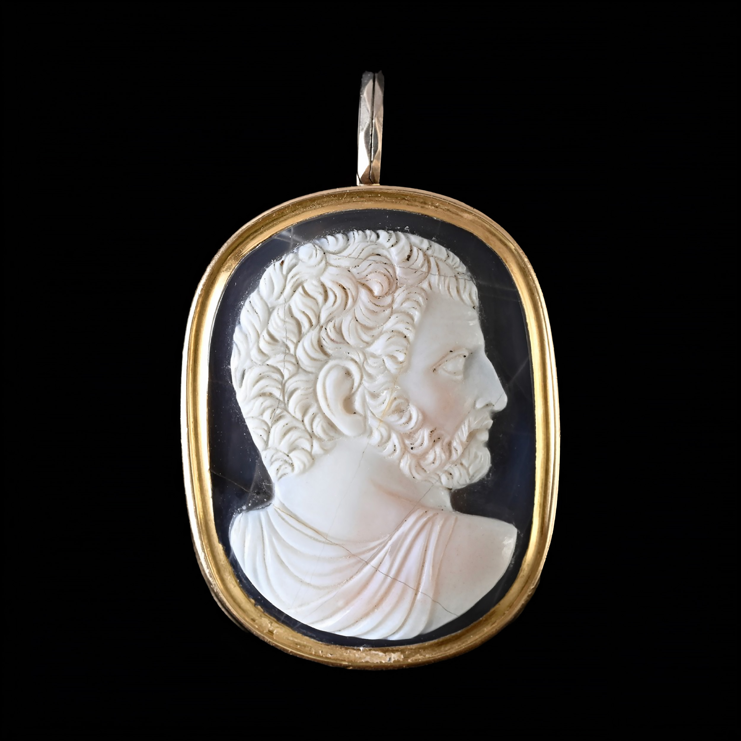 A Grand Tour two-layer agate cameo of a bearded man after the emperor Caracalla, set as a gold pendant.