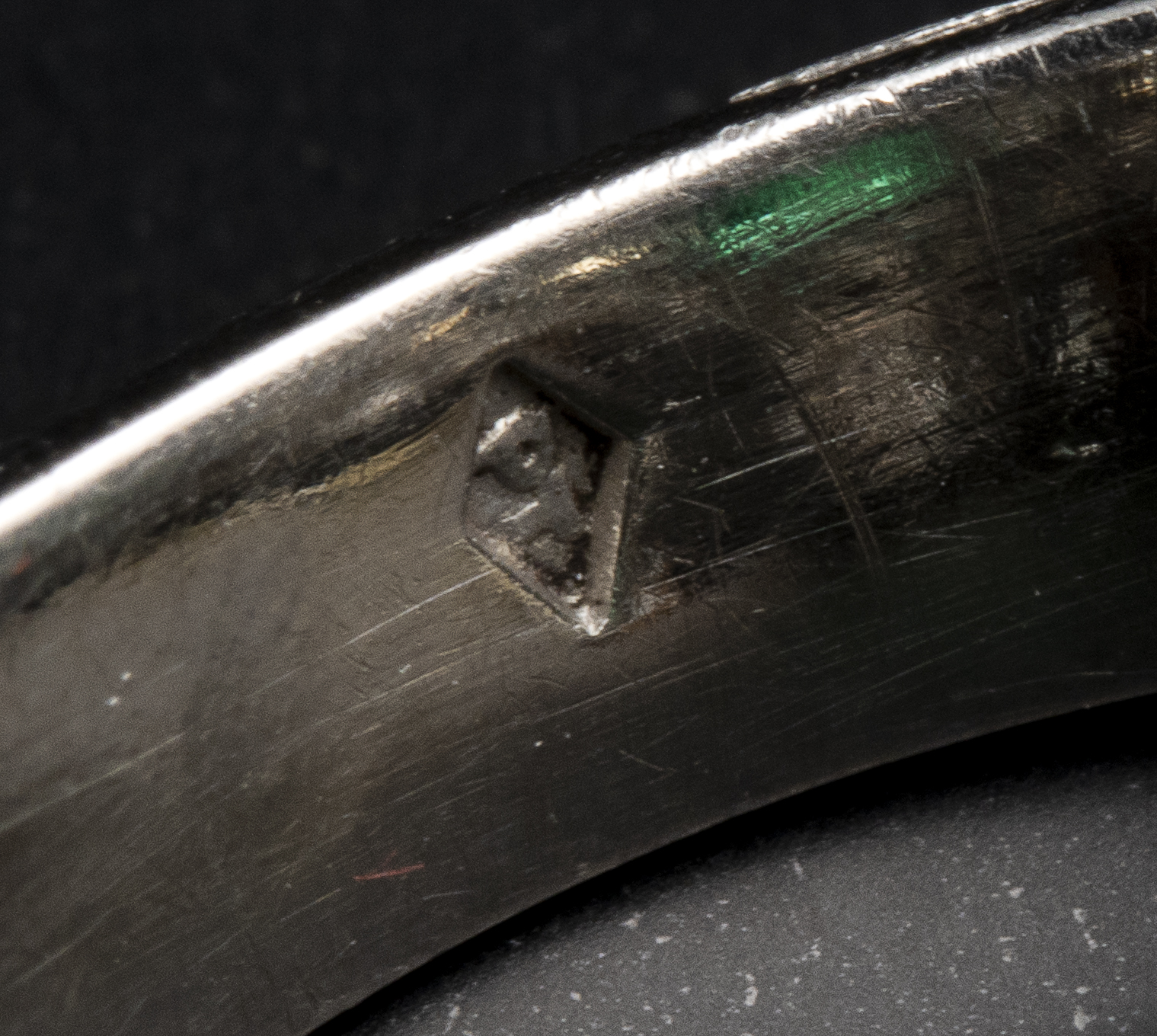 A diamond and platinum ring, set with a rectangular shaped emerald (ca. 1960)