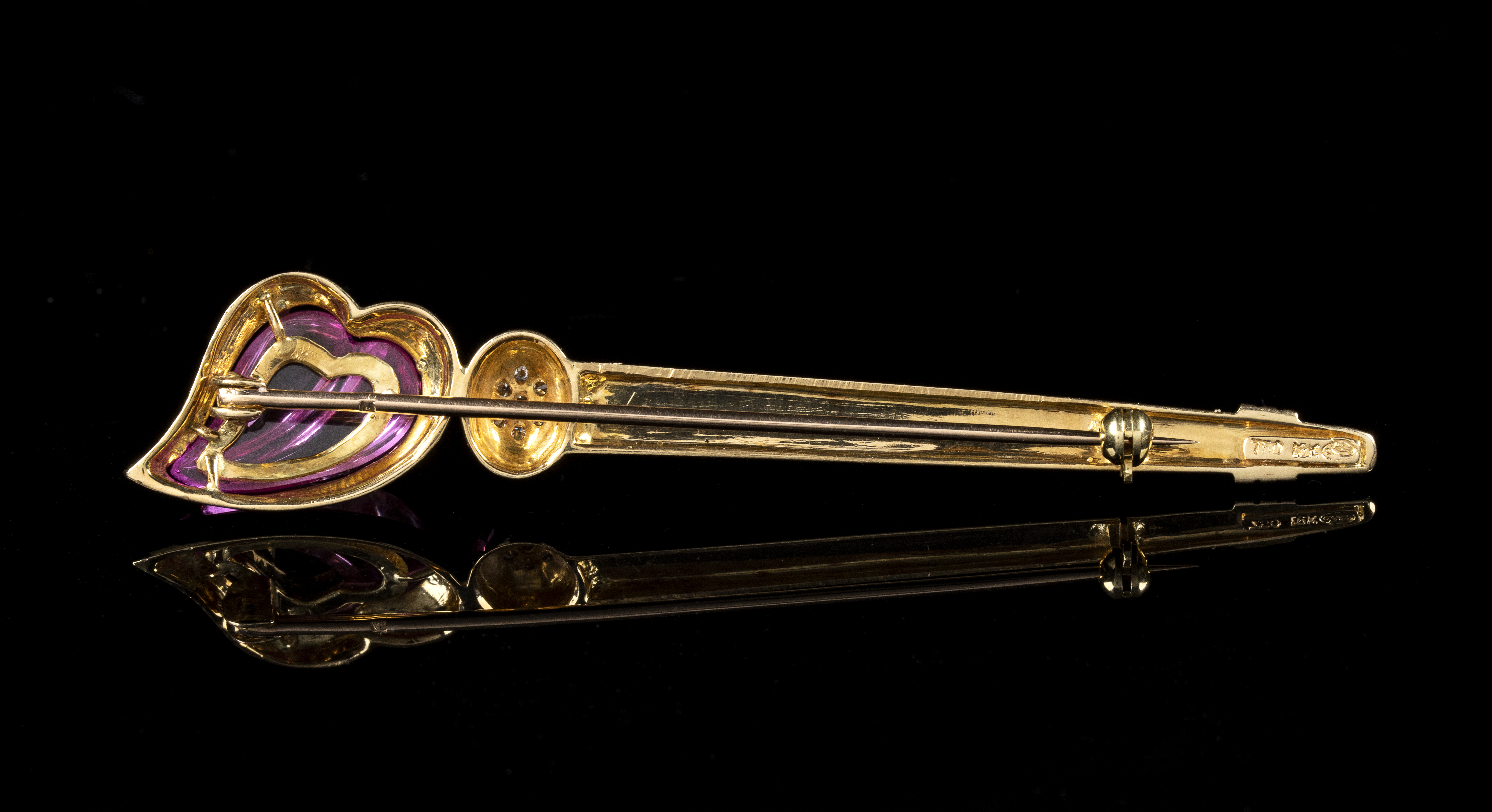 A 18k rose gold bar brooch with pink sapphire