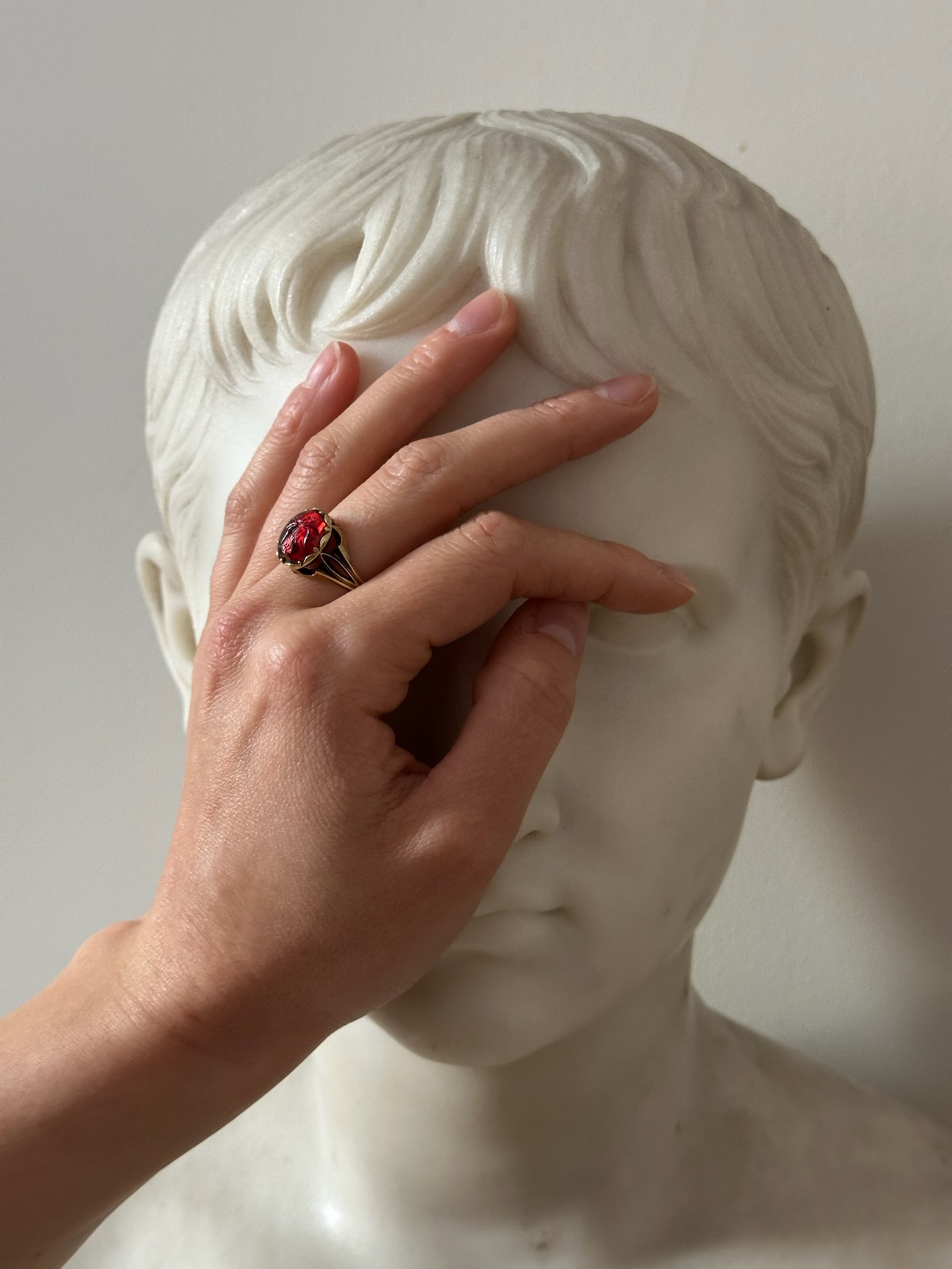 A 19th century gold ring set with an early Roman garnet intaglio. Victory. 