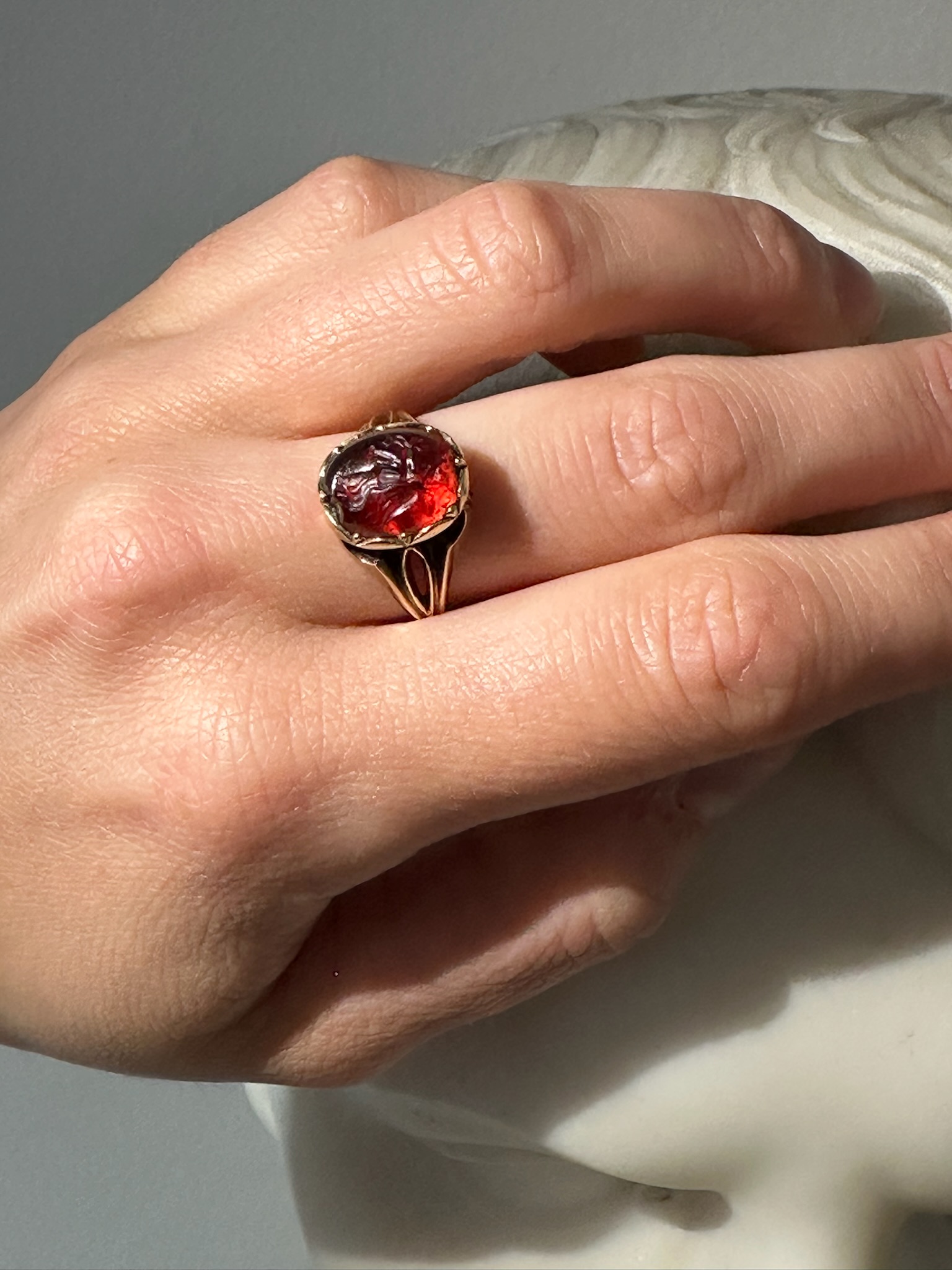 A 19th century gold ring set with an early Roman garnet intaglio. Victory. 