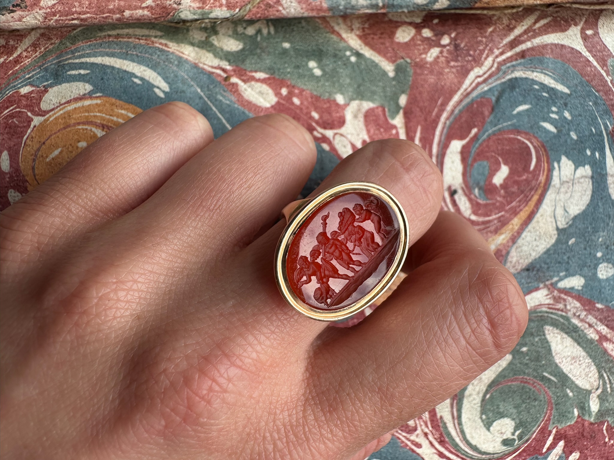 A Late 18th century gold ring set with a carnelian intaglio. The Mariage of Love and Psyche.