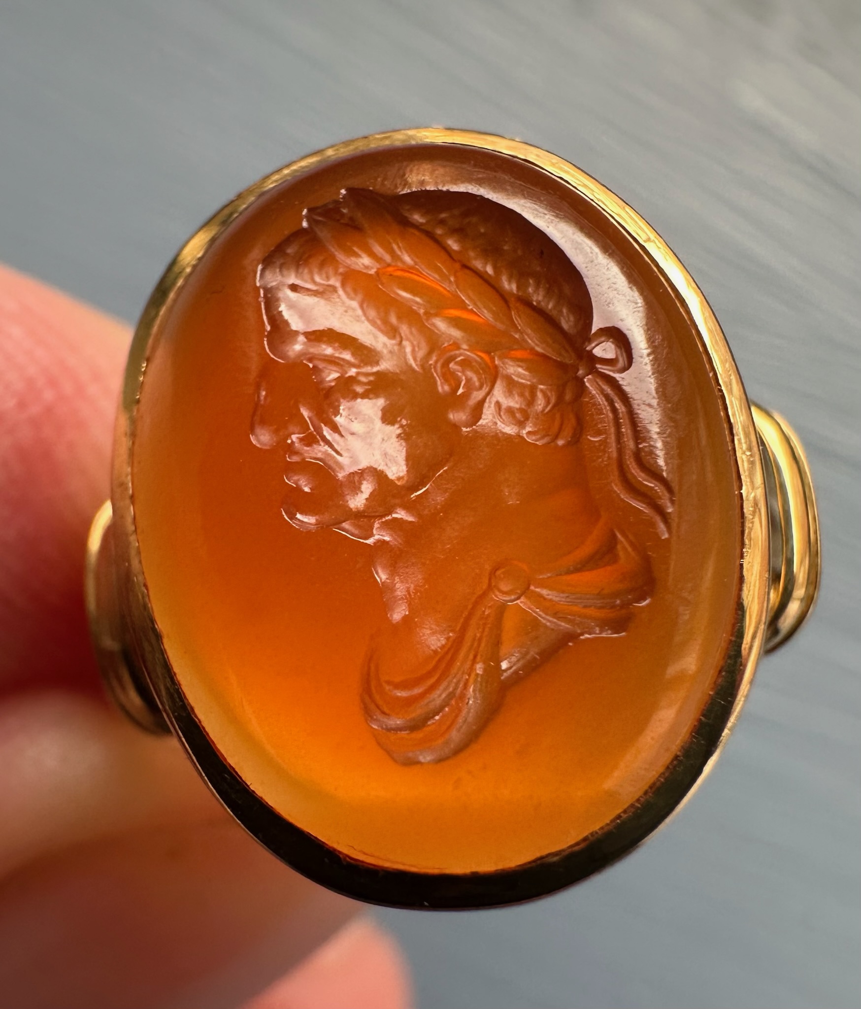 A gold ring set with a 18th century carnelian intaglio. Bust of Galba (reign 68-69 A.D.)