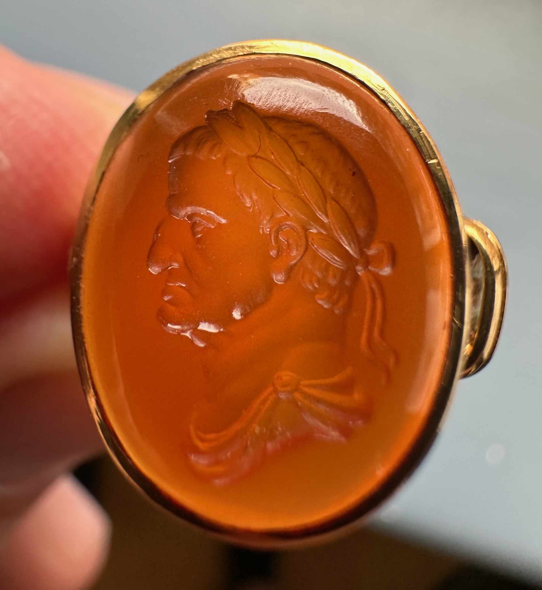 A gold ring set with a 18th century carnelian intaglio. Bust of Galba (reign 68-69 A.D.)