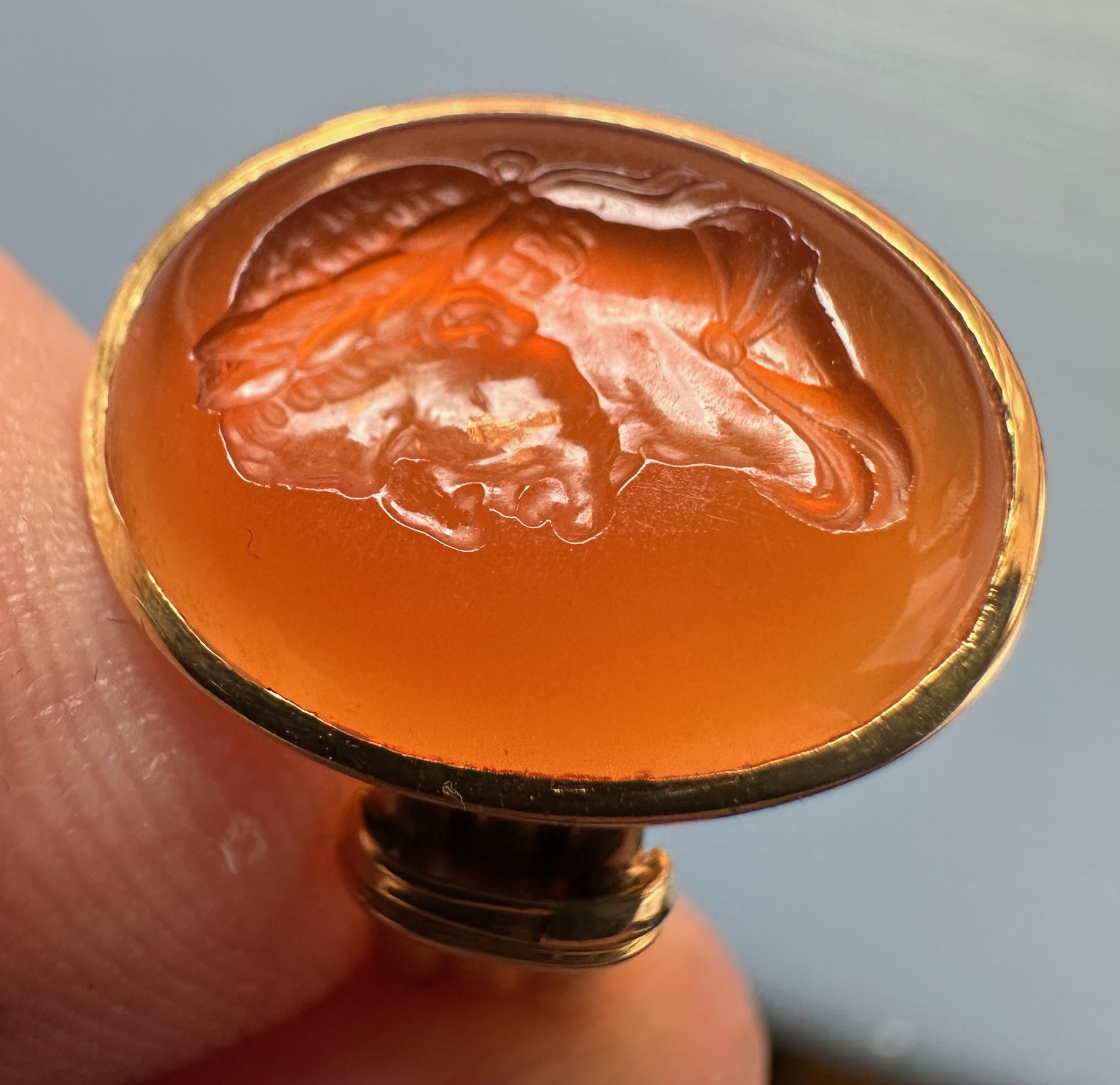 A gold ring set with a 18th century carnelian intaglio. Bust of Galba (reign 68-69 A.D.)