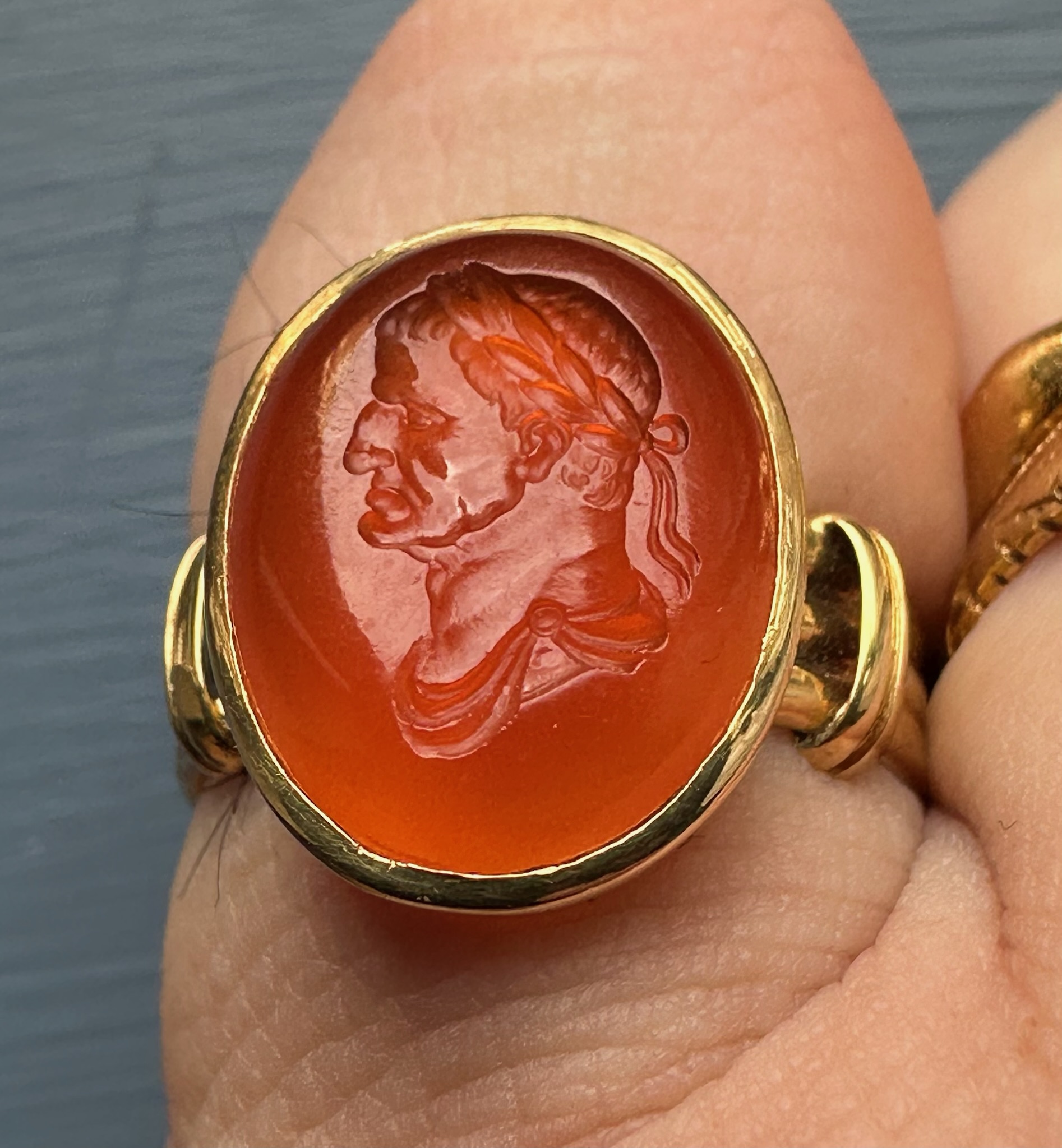 A gold ring set with a 18th century carnelian intaglio. Bust of Galba (reign 68-69 A.D.)