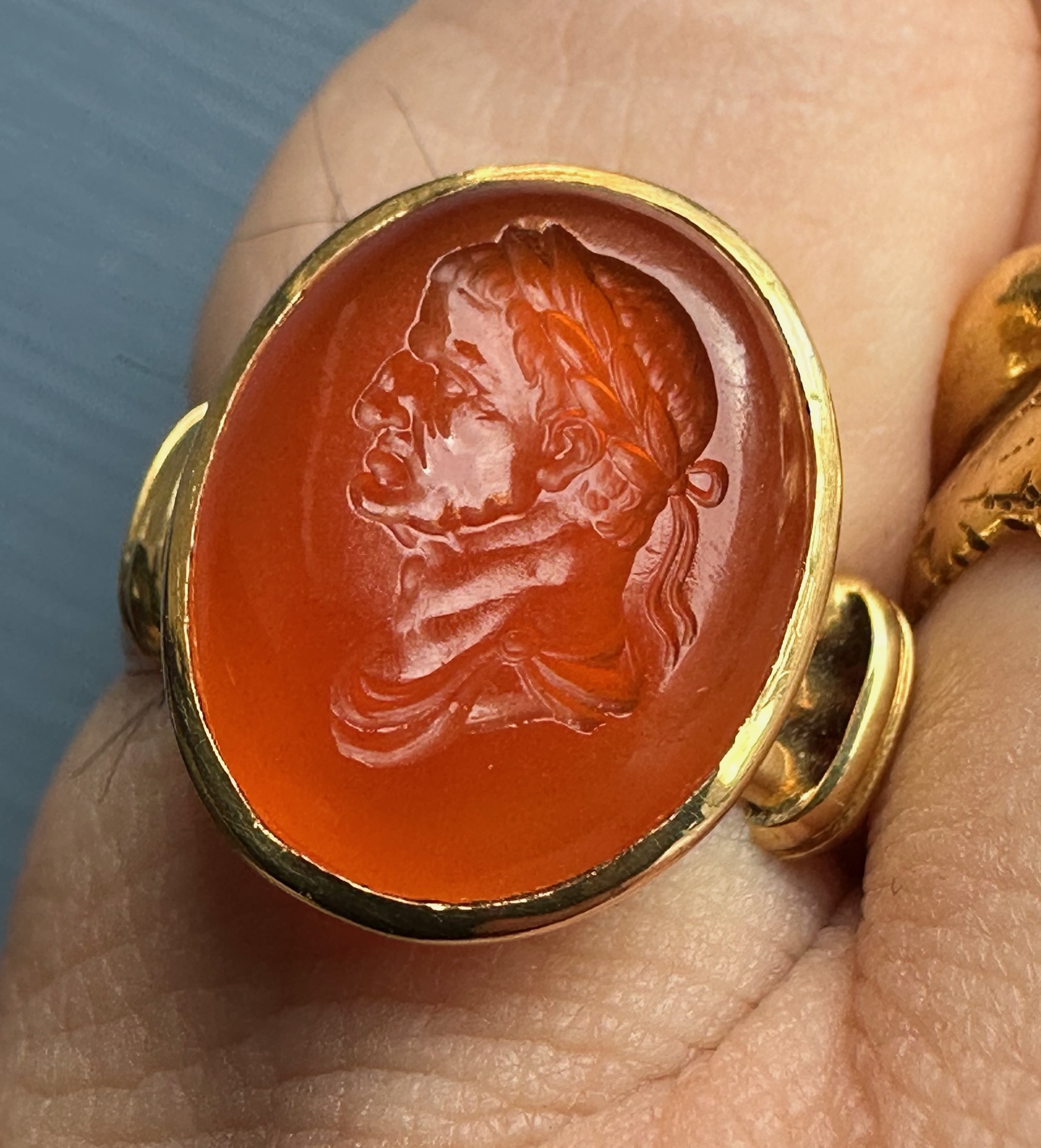 A gold ring set with a 18th century carnelian intaglio. Bust of Galba (reign 68-69 A.D.)
