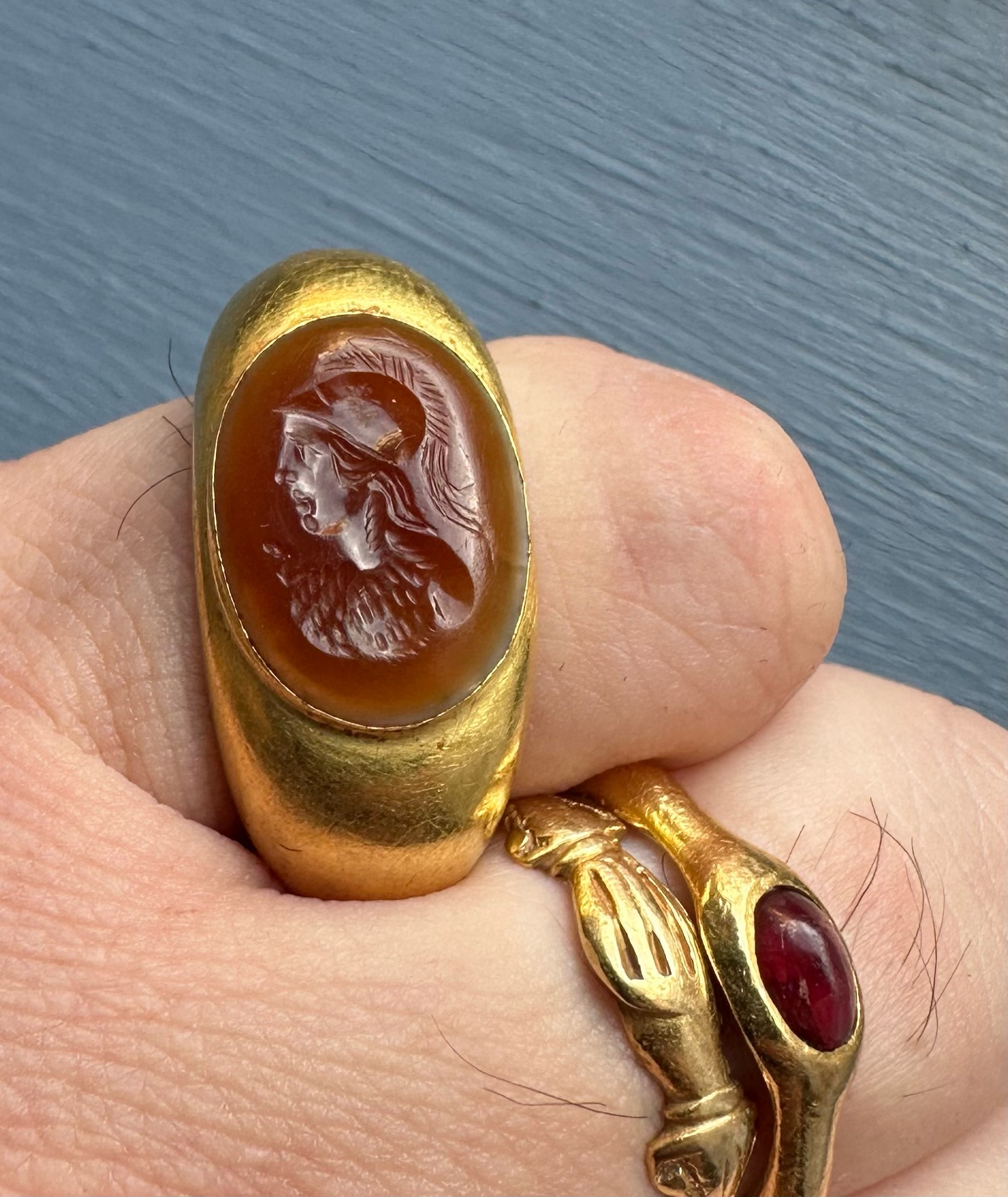 A large Roman hollow gold ring set with an agate intaglio. Bust of Athena.