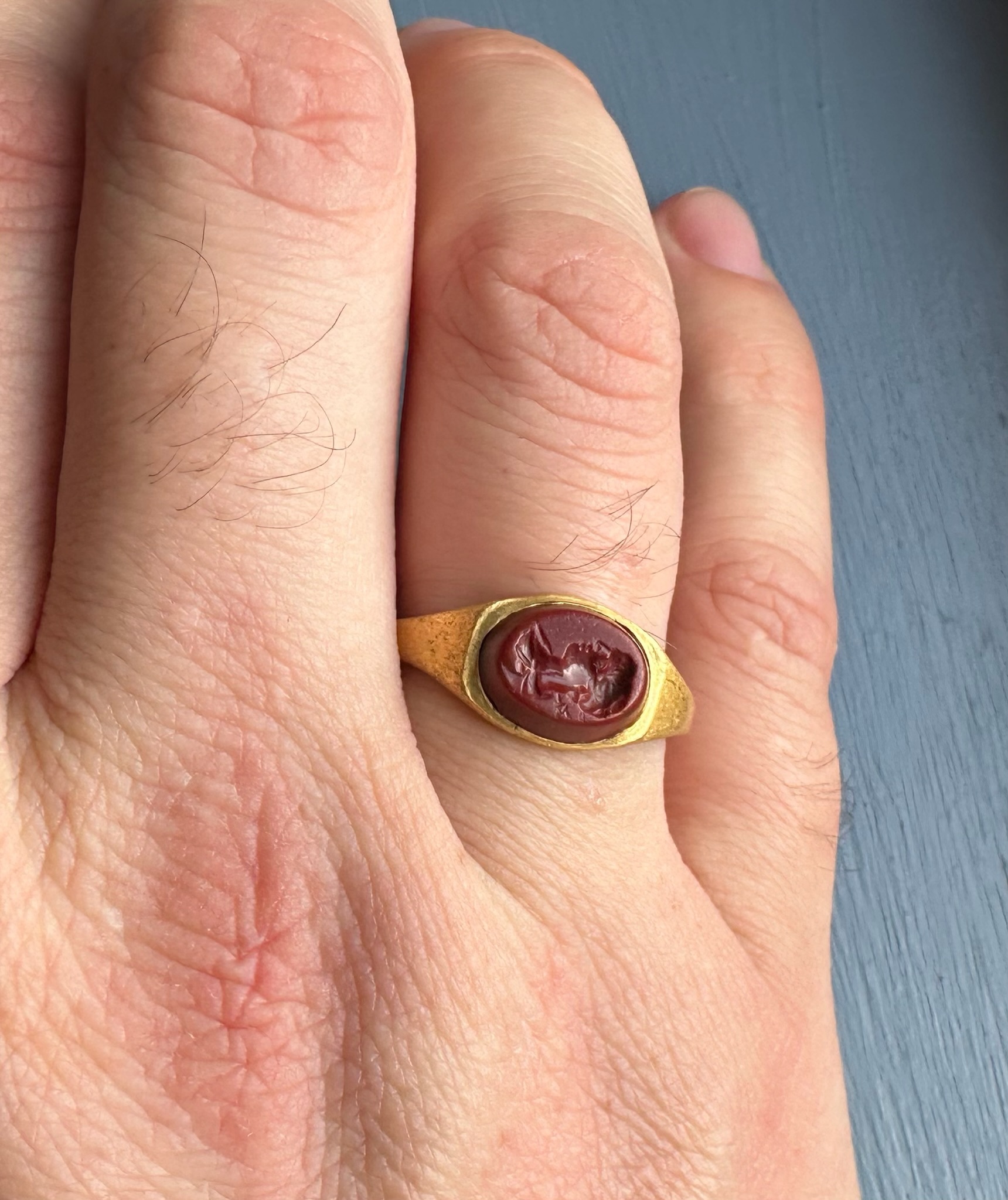 A Roman gold ring set with a red jasper intaglio. Bust of Mercury. 