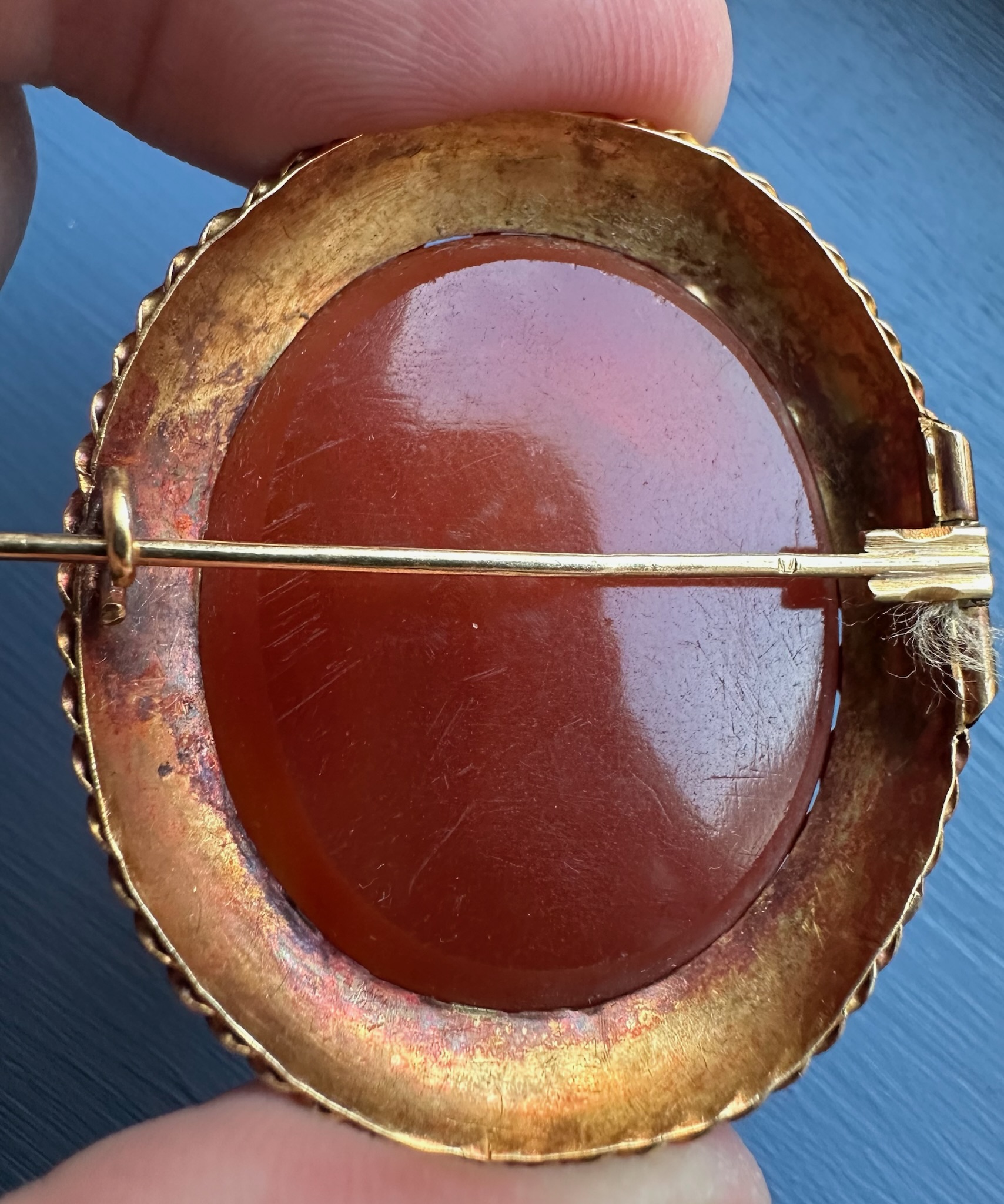 A 19th century gold brooch set with a large carnelian intaglio. Portrait of an Hellenistic ruler.